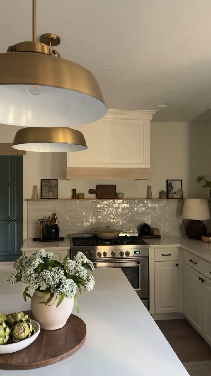 Neutral Kitchen | styled Kitchen | kitchen counter styling | wood tray | kitchen pendant lights | countertop decor | centerpiece decor | faux artichokes | cutting board | wood pedestal board 

#LTKfindsunder50 #LTKhome #LTKfindsunder100