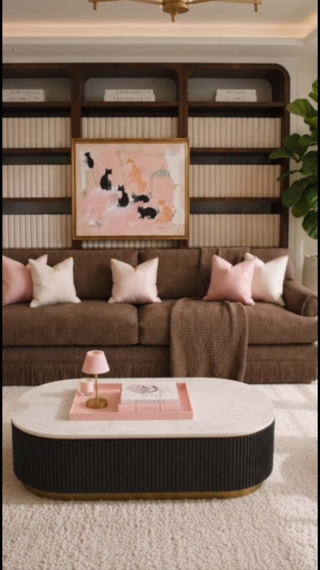 A modern classic living room that proves timeless design never goes out of style.

I love the warmth of a chocolate brown sofa reimagined with a tailored fringe detail, paired with a soft blush accent chair that adds just the right touch of femininity. The reeded marble coffee table brings texture and sophistication, while layers of pink and ivory pillows keep the space feeling fresh, light, and inviting.

From the statement bookcase and elegant table lamp to the oversized planter, ottoman, and plush area rug, every piece works together to create a collected, elevated look that feels both chic and comfortable.

A beautiful reminder that classic design can feel current, relaxed, and effortlessly livable.#LivingRoomDesign #ModernClassic #ChocolateBrownSofa #FringeSofa #AccentChair #CoffeeTable #BookcaseStyling #PinkDecor #NeutralDecor #LuxuryInteriors #TraditionalWithATwist #InteriorStyling #HomeDecorInspo #TimelessDesign #AreaRug #TableLamp #Ottoman #DesignerLookForLess #LTKStyle #art #drapes #tray #rechargabletablelamp #homedecor

#LTKHome #LTKSeasonal #LTKHome #LTKSaleAlert
