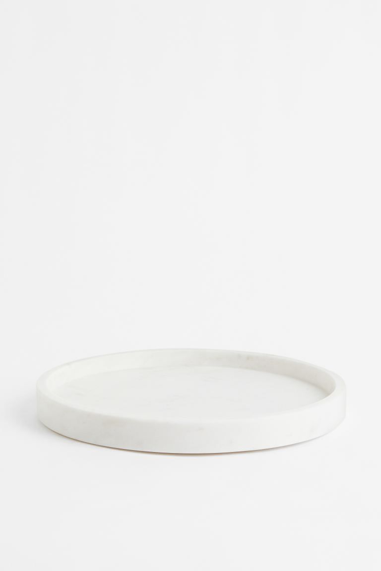 Premium SelectionRound tray in marble with a low rim and silicone feet. Height 1 in. Diameter 10 ... | H&M (US)