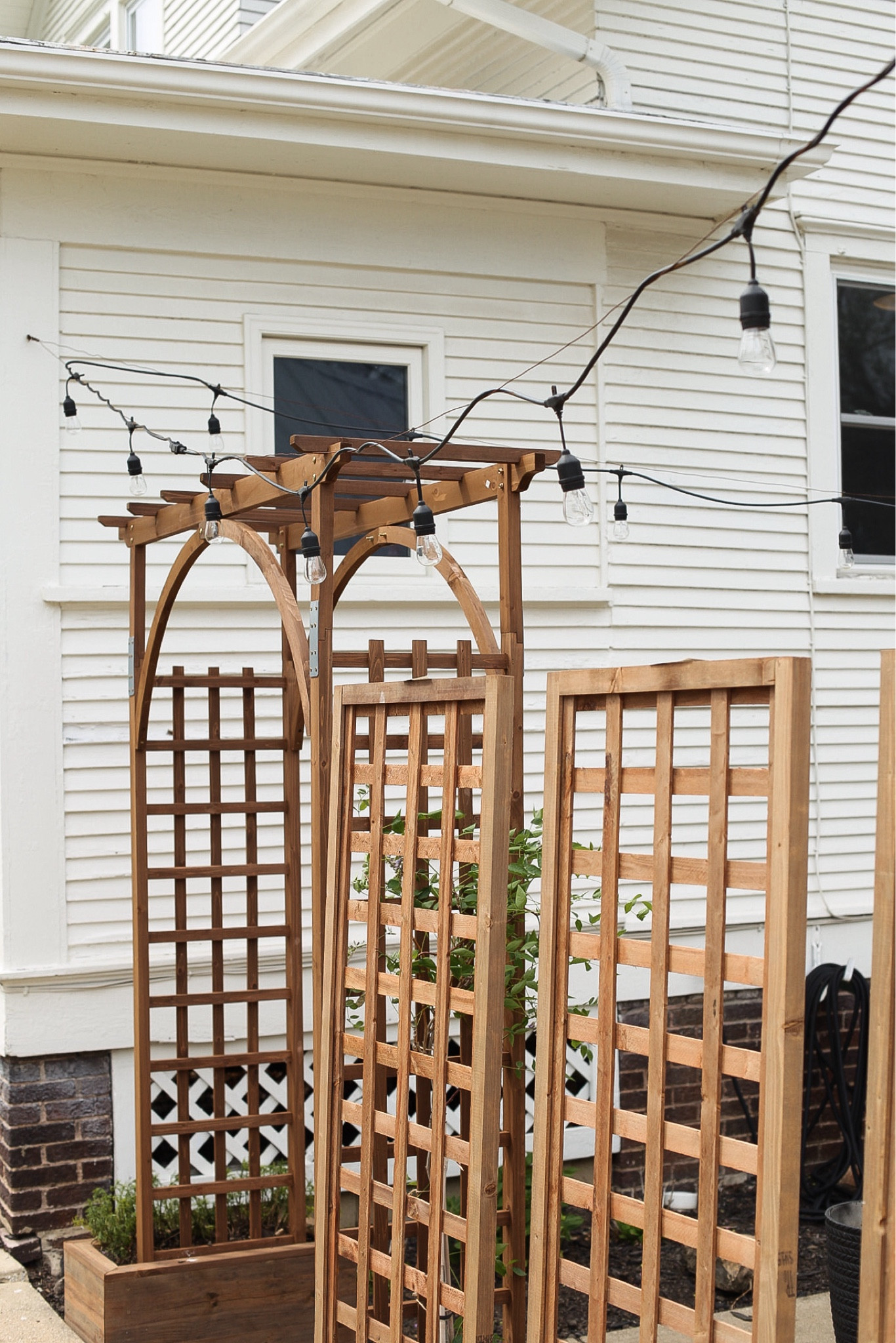 These privacy trellises are my favorite landscaping addition this year. And of course this arbor 😊 Outdoor living. Spring gardening. Garden finds  

#LTKhome