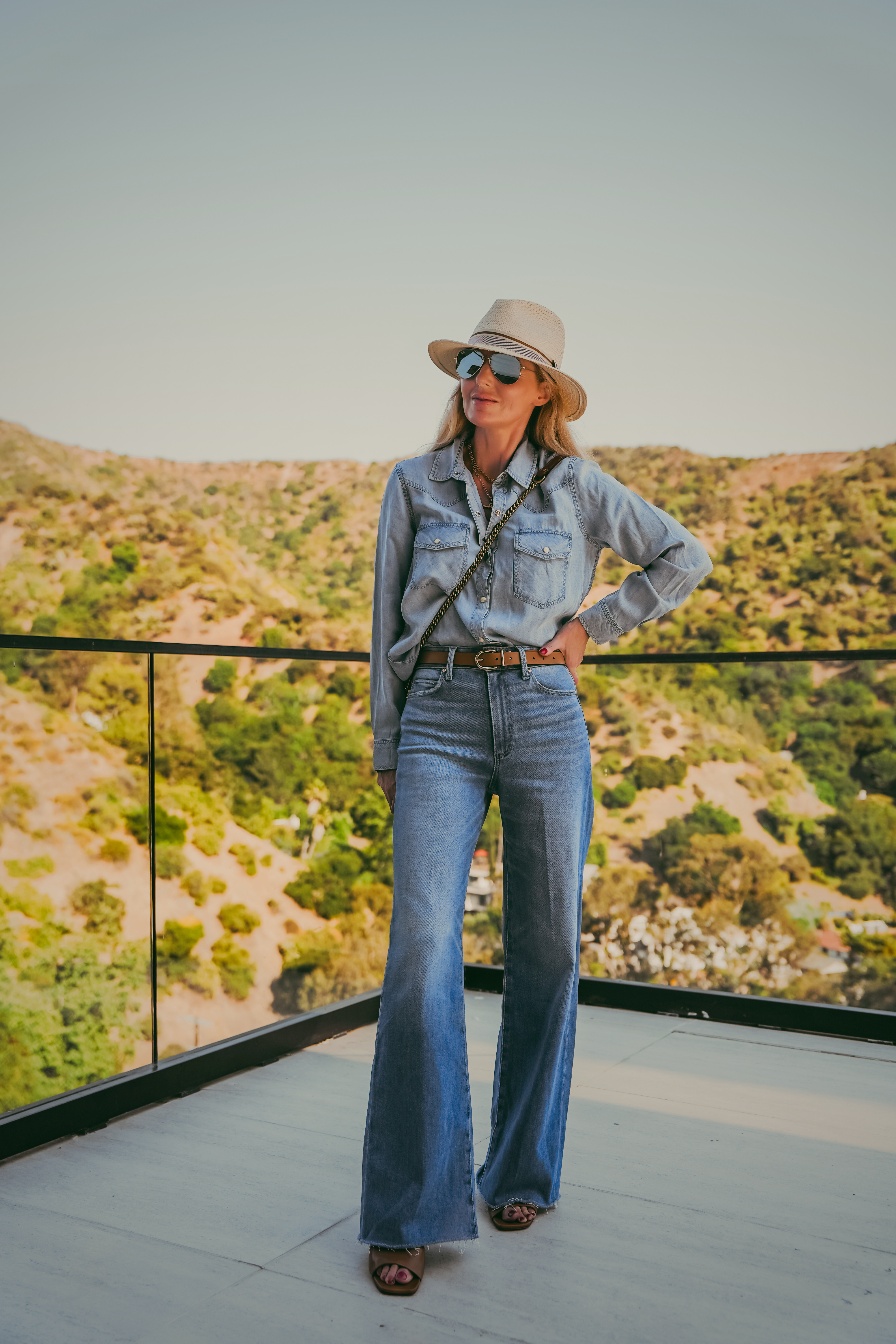 Here's what wide leg jeans actually do for your proportions; they create a long unbroken line from hip to hem that makes you look taller and leaner!

The Paige Anessa does this better than almost any other wide leg jean out there. High rise, clean wide leg, frayed hem. Styled with a Rails chambray top, Rag & Bone straw hat, tan leather belt, and a chain crossbody.

#LTKgrwm #LTKootd #LTKOver40