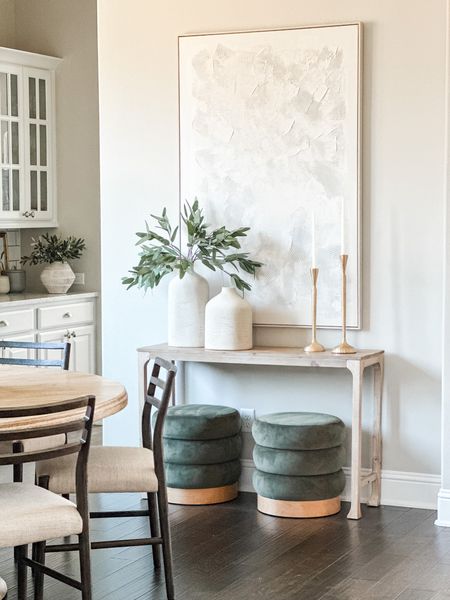 To date your favorite styling is made up of my affordable console table and ottomans. The oversized art is a best seller and the hearth and hand vases from @target are actually some of my personal favorites! Take in this view with my previous dining room chairs that have now been changed. 

#LTKhome #LTKsalealert #LTKstyletip