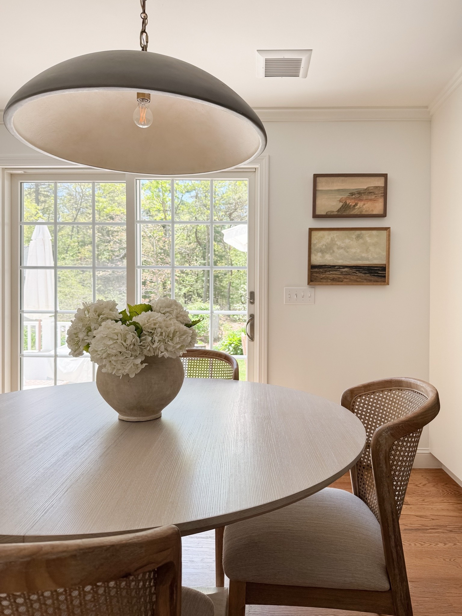 coastal dining room decor, round wood dining table, woven dining chairs, faux hydrangea centerpiece, neutral dining room styling, coastal interior decor, light coastal home, neutral dining room inspiration, sherricalnanhome

#LTKHome