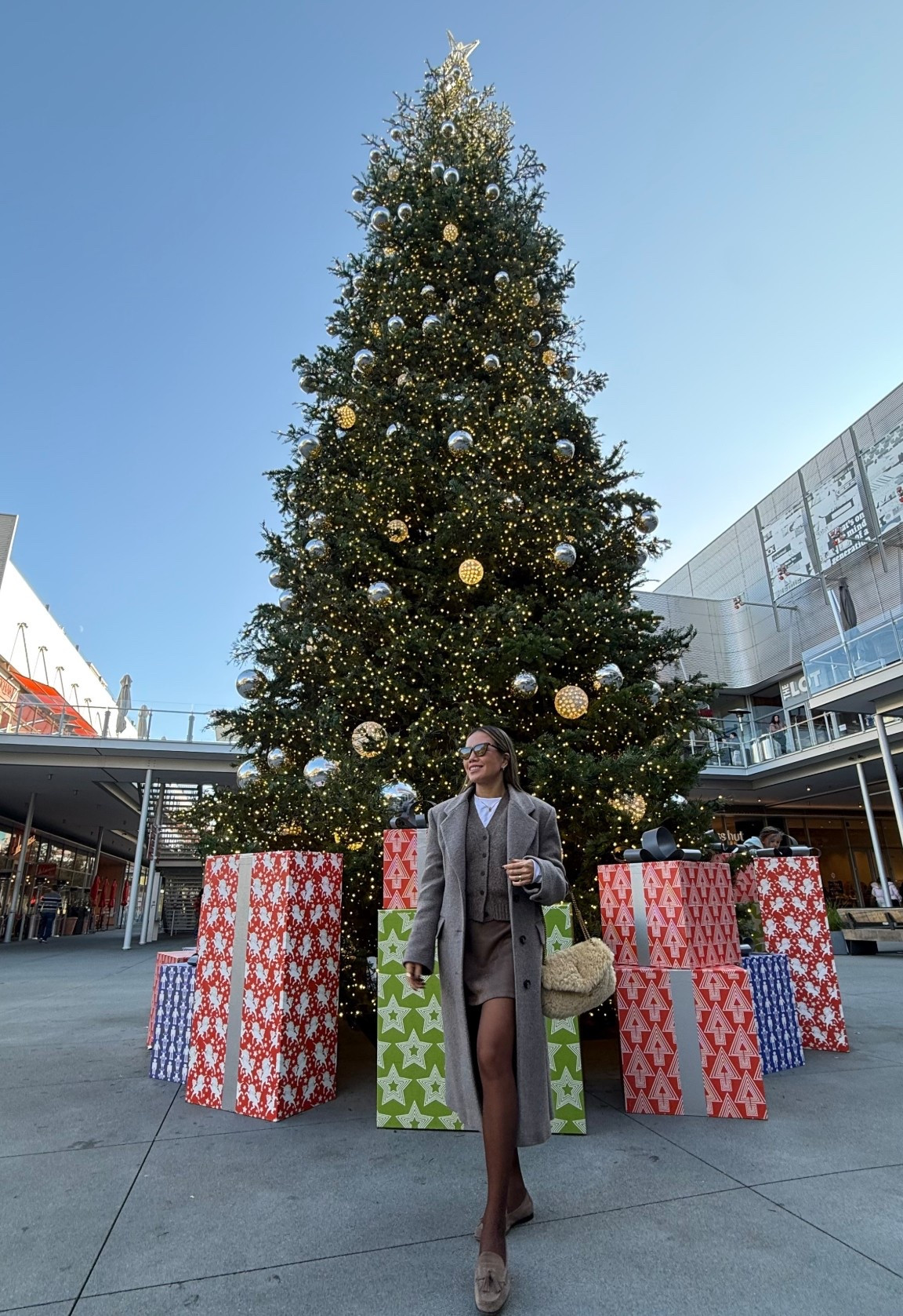 Brown grey monochromatic winter outfit. White long sleeve tee shirt, wool v-neck button cardigan, brown faux suede skirt, long wool coat, and suede penny loafer. My YSL shearling paired perfectly with this outfit. 