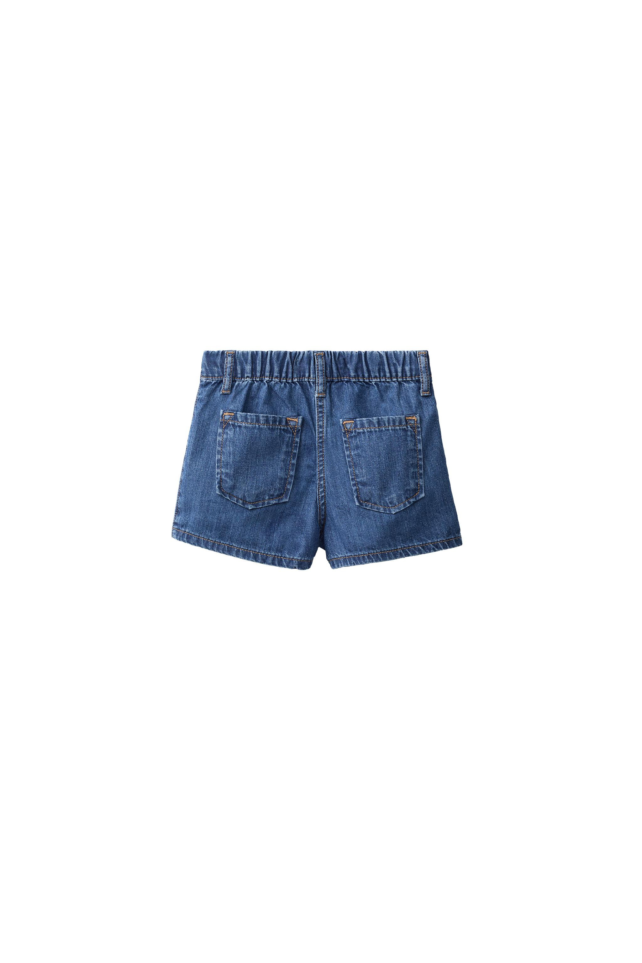 Skort with elastic waistband and crossover snap button closure. Front pockets and back patch pock... | Zara US