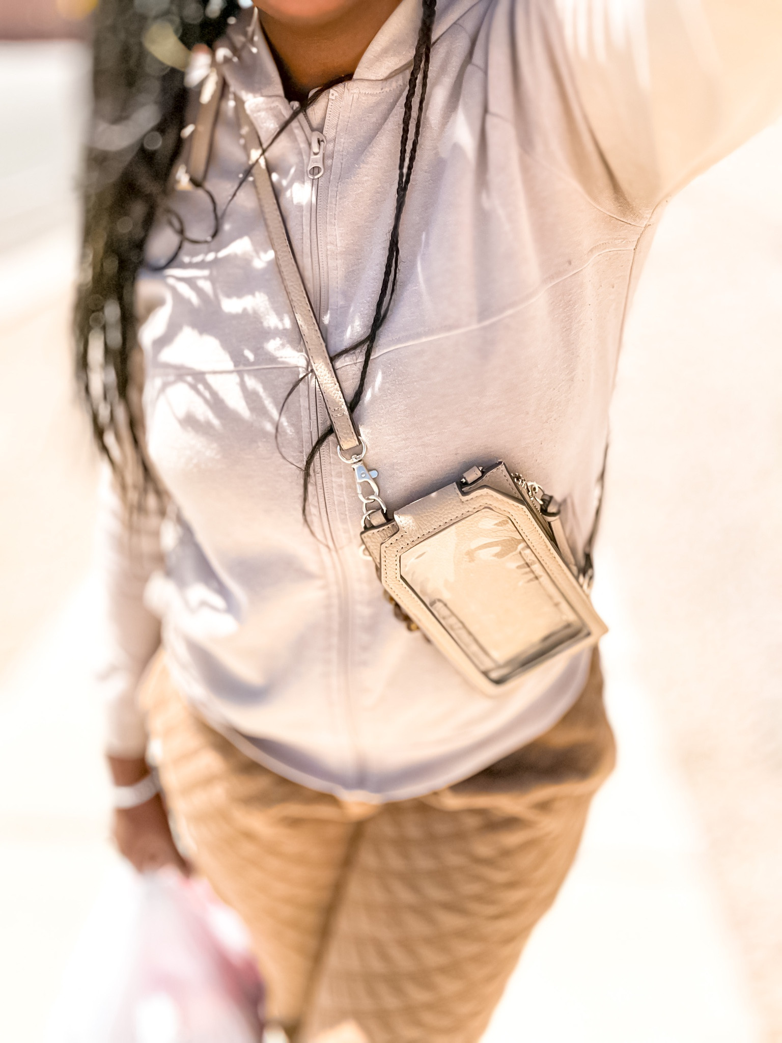 Spring Time Crisp calls for a Light Sweater and Joggers Travel Outfit Idea. Wanting to travel lightly, this adjustable sling wallet was perfect to carry the bare essentials, card, cash, keys, and has a transparent pocket for your phone. I got crafty with the straps, adding a hole to the bottom lining & attached the removable strap to have one on each side so it could be wearable as a cross body. 

Doing so makes it harder for thieves to steal from you.

Plus you can adjust the straps, and trim the excess, to wear it even higher, right next to your heart.

Plus if your a wristlet kind a gal, the straps come off, and there’s a cute see through leopard print chain handle. 

I found that to be less secure for traveling, but convenient for going to your Girl’s house for Girl chat, drinks & snacks! 

Plus it’s a cute quick run to the store, near the hotel stroll, or out for light shopping bag. 