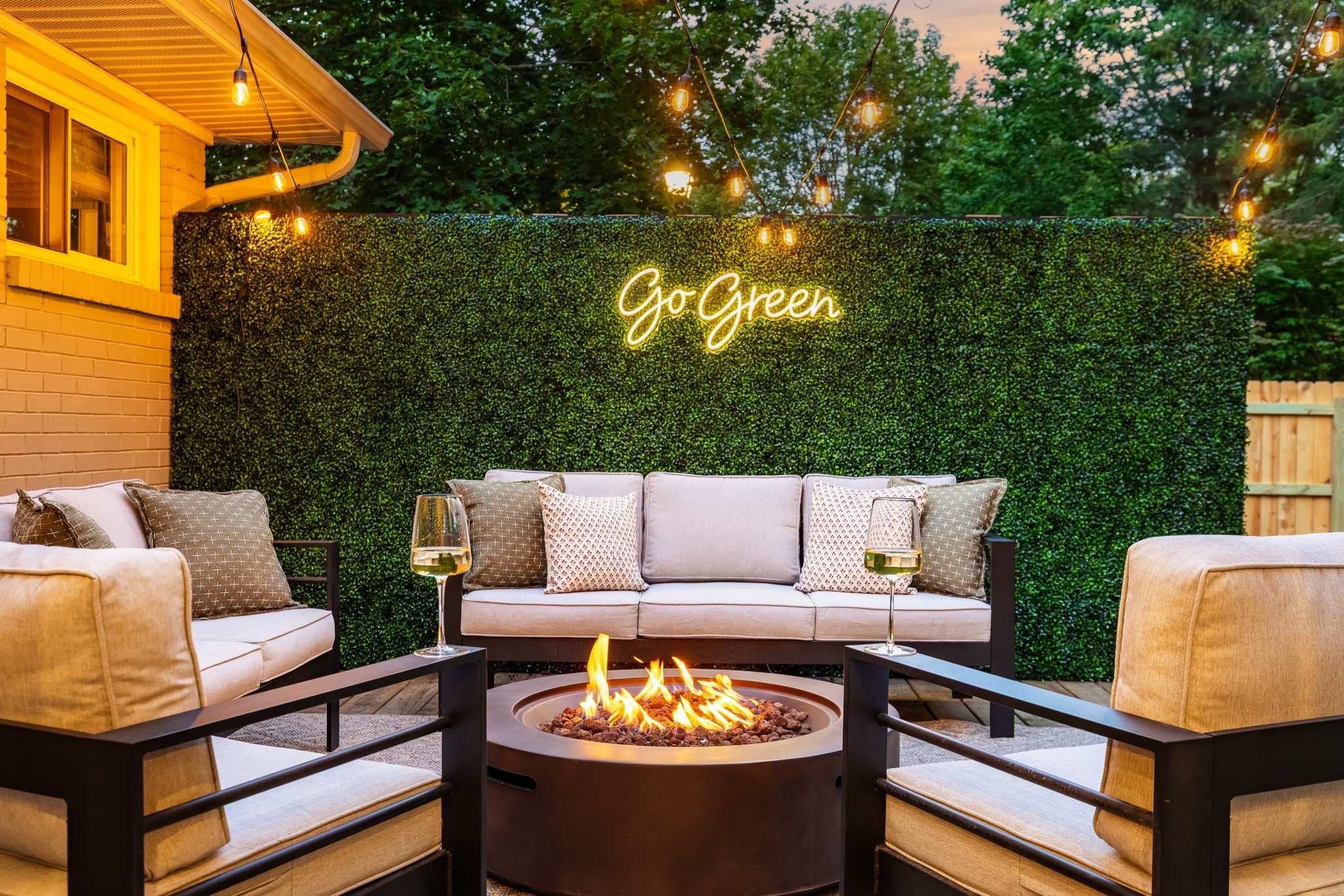 Outdoor patio at The Linden House ✨ 

#outdoorfurniture #greenerywall #neonsign #firepit #outdoorrug 

#LTKHome