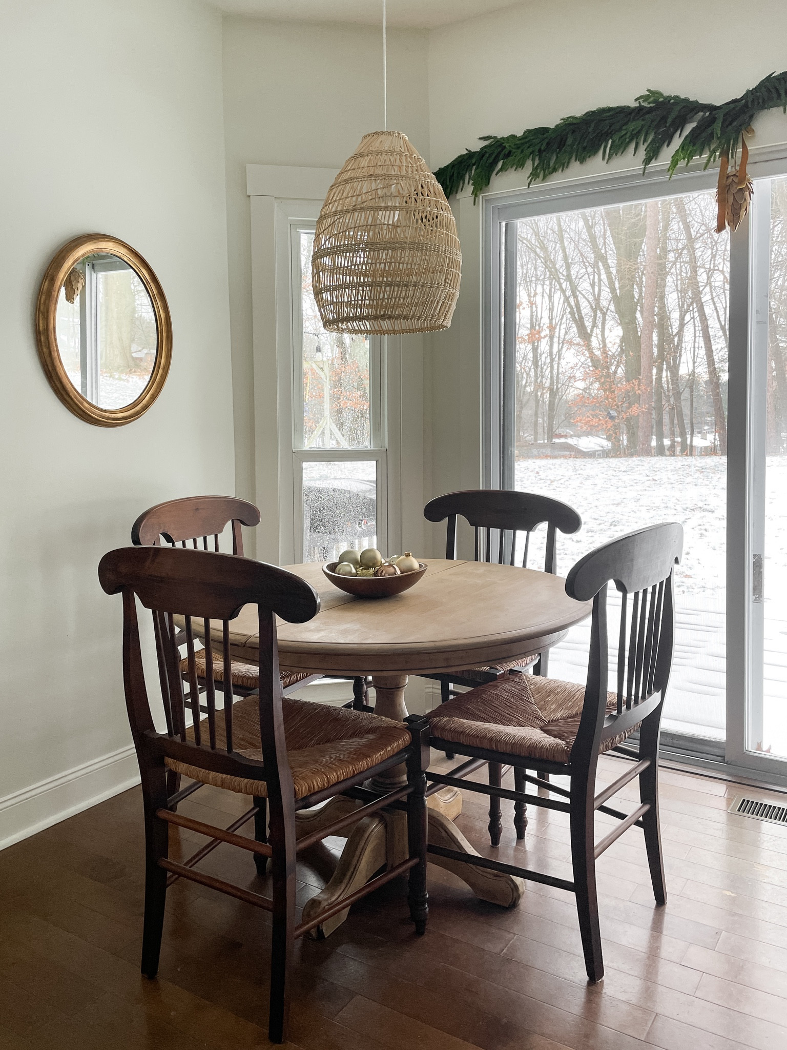 Our kitchen nook all decorated for Christmas with the Norfolk pine garland.  

Kitchen table.  Kitchen rusk seat chairs.  Gold mirror.  Basket pendant light.  Garland.  Christmas decorations.  

#LTKhome #LTKHoliday #LTKSeasonal