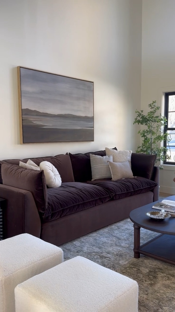 Beautiful brown sofa with vintage inspired coffee table, boucle ottomans, and neutral rug. 

Living room, rug, sofa, ottoman, oval coffee table, oak coffee table 

#LTKHome