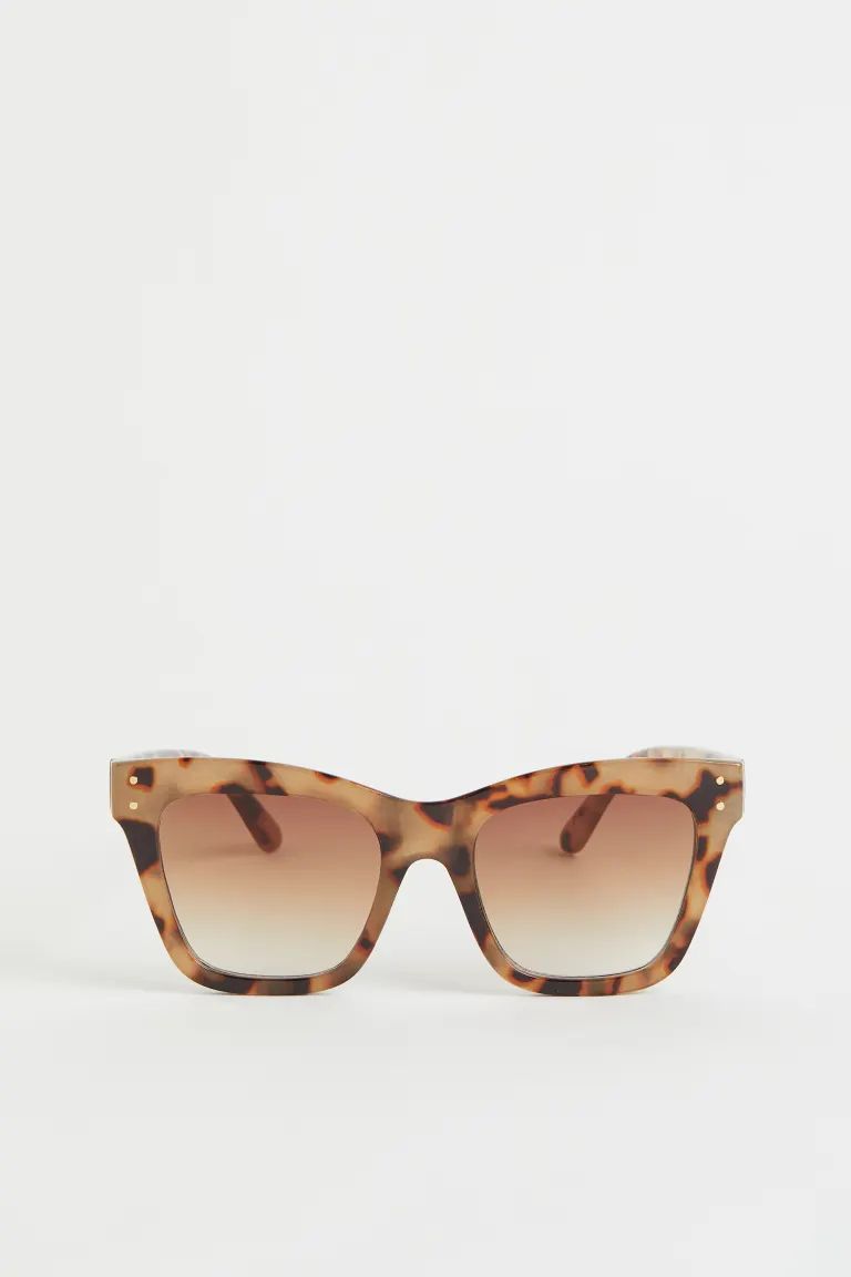 Large, cat-eye sunglasses with frames, lenses, and sidepieces in plastic. Tinted, UV-protective l... | H&M (US + CA)