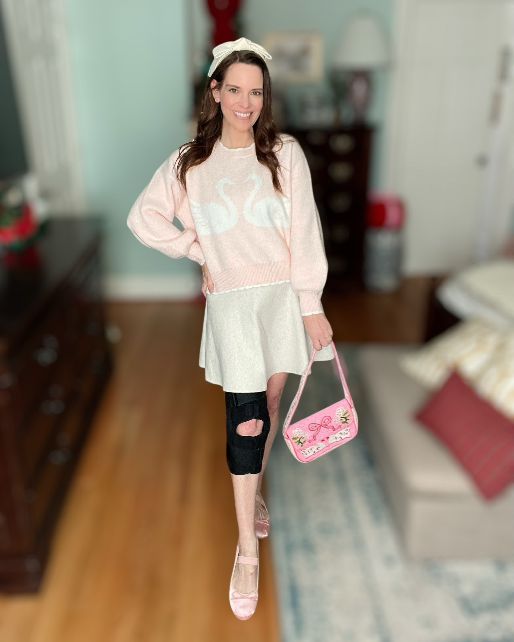 Pretty in Pink Swan Sweater Outfit 🦢✨

This outfit is giving sweet, feminine, and cozy all at once 💕 The scalloped swan sweater is such a standout and feels so much more expensive than it is. I styled it with a soft mini sweater skirt for an easy, polished look that’s still comfortable and wearable. The bow headband adds the prettiest finishing touch, and the pink ballet flats tie everything together perfectly 🩰💗

The completely beaded swan shoulder bag is the star accessory here — so detailed, playful, and full of charm. It adds texture and makes the whole outfit feel extra special without being over the top 🎀✨ I’m also wearing a knee brace after fracturing my fibula head, which is a reminder that you can still feel cute while prioritizing comfort and support 🤍

Pink sweater outfit, swan sweater outfit, beaded handbag, bow headband style, ballet flats outfit, feminine winter outfit, cute casual outfit ideas, affordable boutique finds, Target skirt outfit, cozy chic style

#LTKGiftGuide #LTKHoliday #LTKFindsUnder50