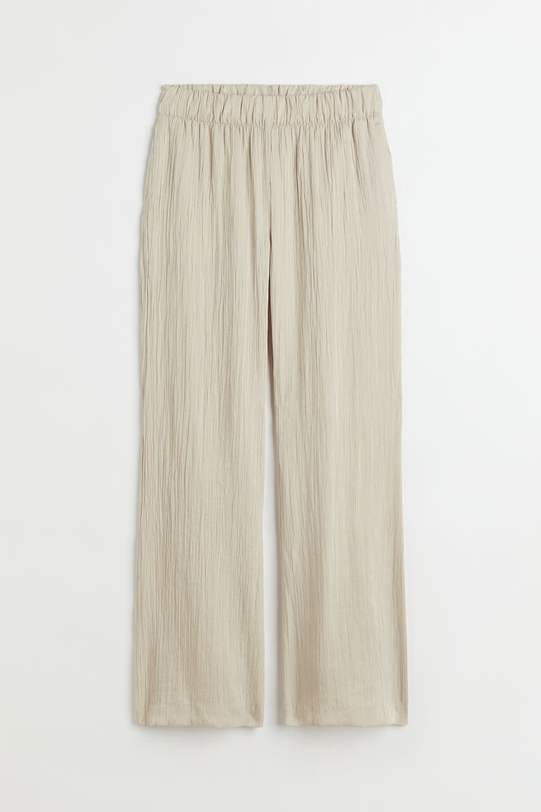 Pants in a woven, crinkled fabric with flared legs. High waist, wide waistband with covered elast... | H&M (US + CA)