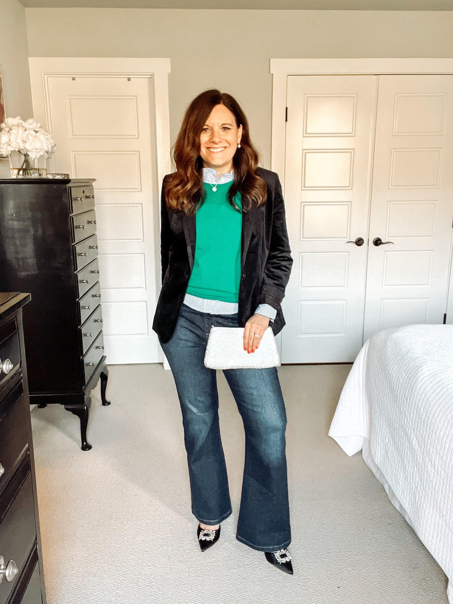 Wearing a pop of color with your velvet blazer gives a fun twist to your look. This outfit is preppy from the striped ruffle-neck blue button-down shirt and the green vest. But it’s also so festive, thanks to the pointy-toe satin shoes with rhinestones and this rhinestone clutch bag, which are both Amazon finds. They look amazing with this velvet blazer! Try solid colors, especially gem tones, with your velvet blazer for a chic look. I sized up in these Gap flare jeans and am wearing the short length for flat or nearly flat shoes. 

#LTKOver40 #LTKHoliday #LTKMidsize
