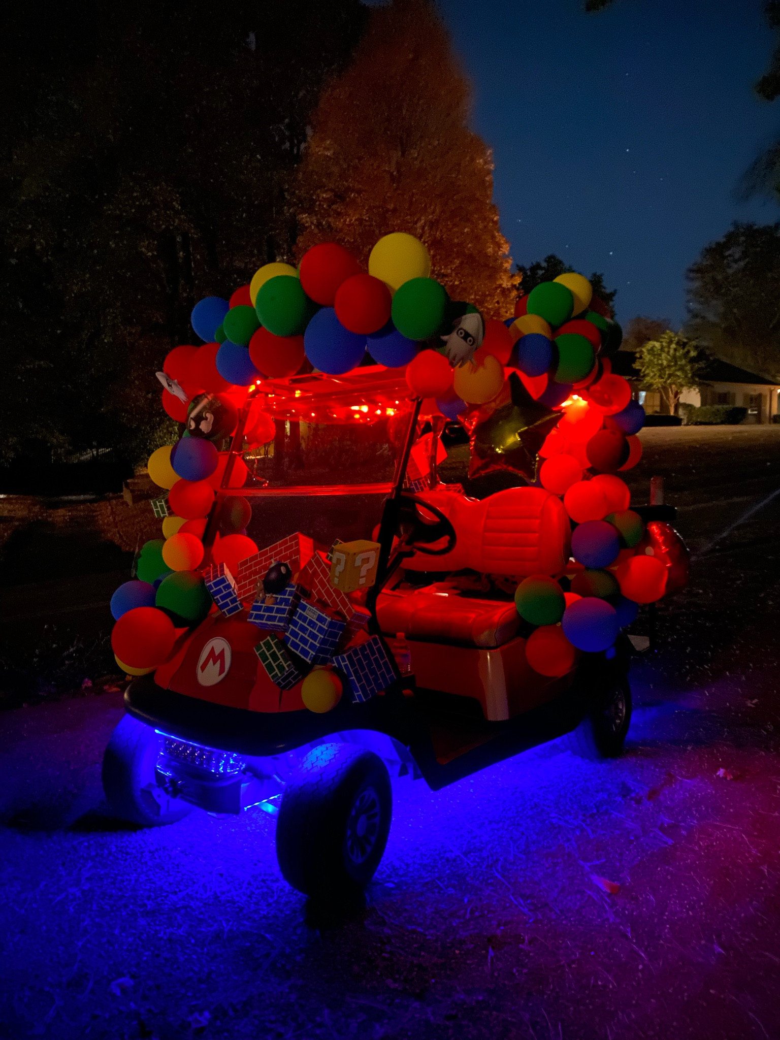 The cart was next level with the lights! LED strip lights on the bottom, stuck to the underside, string lights on top, hung by stick on hooks. Power source is the batter pack, all connected by USB plugs with that multi-pronged adapter.

#LTKfamily #LTKHalloween