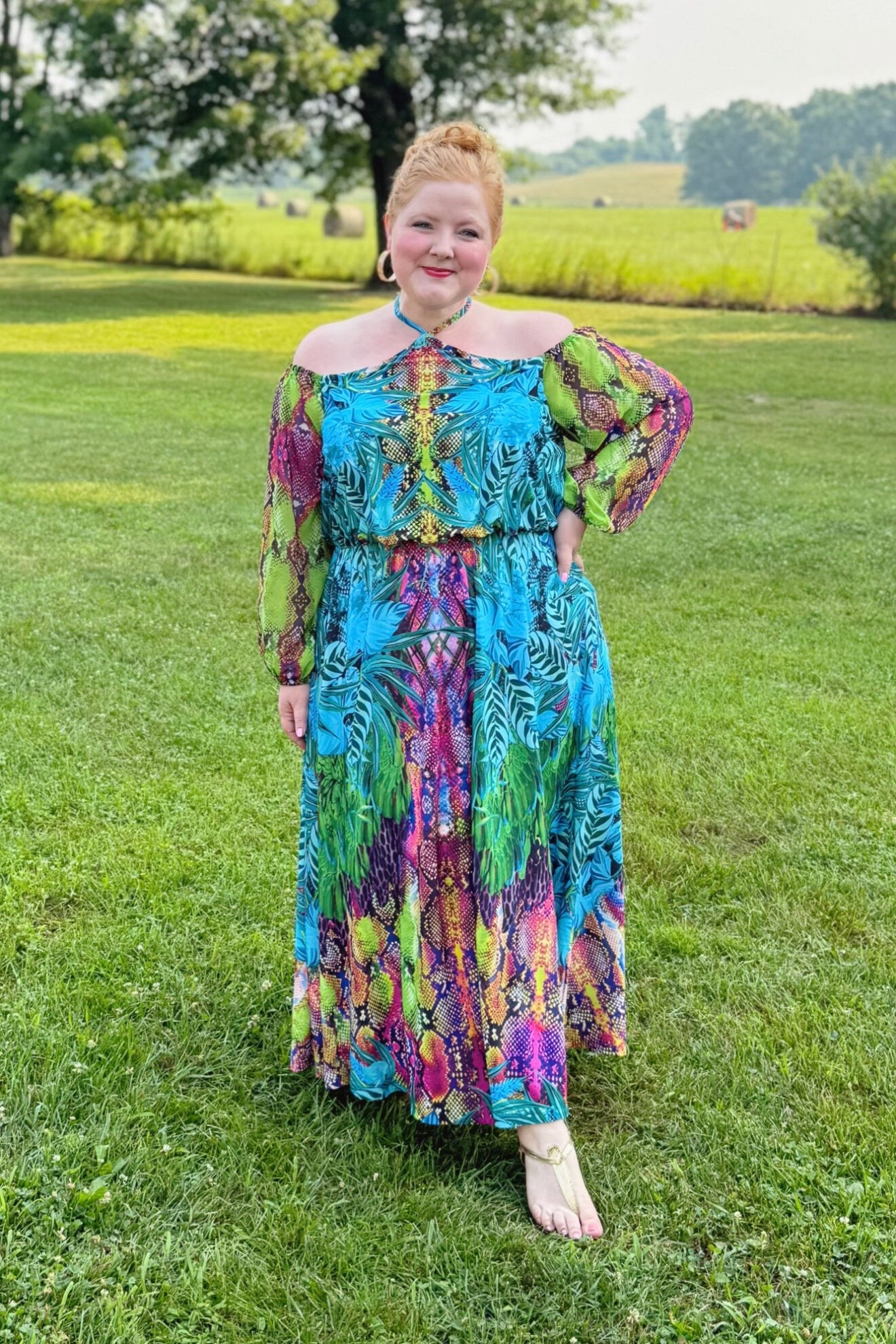 Rainbow Snake Print Maxi Dress Outfit

I’m wearing this Jungle Kaleidoscope Cold Shoulder Dress (sizes 12-26; $99.95) in the size 16. The body of the dress is cut from a weighty and flowy polyester knit with a good amount of stretch. The sleeves are a sheer poly chiffon, and the waist is elasticized. The design of the top of this dress is so smart and really prioritizes comfort and wearability. Between the elastic waist and the off-shoulder neckline which is also elasticized, that’s what’s truly holding the dress up. The halter is more for looks than for actually holding up the dress. I typically find halter necklines super uncomfortable and they leave my neck and back feeling sore, but not this one.

I wore this dress to Kesha’s Tits Out Tour, and the flowy fit of the dress kept me comfortable and cool in the heat. The colors and animal prints were so on point for Kesha. And I got several compliments on it! The dress also comes in a more classic animal print if the rainbow is too much for you. But too much is never too much for Kesha! Shop the dress for just $65 with my code WWWULLA. 

#LTKootd #LTKMidsize #LTKPlusSize