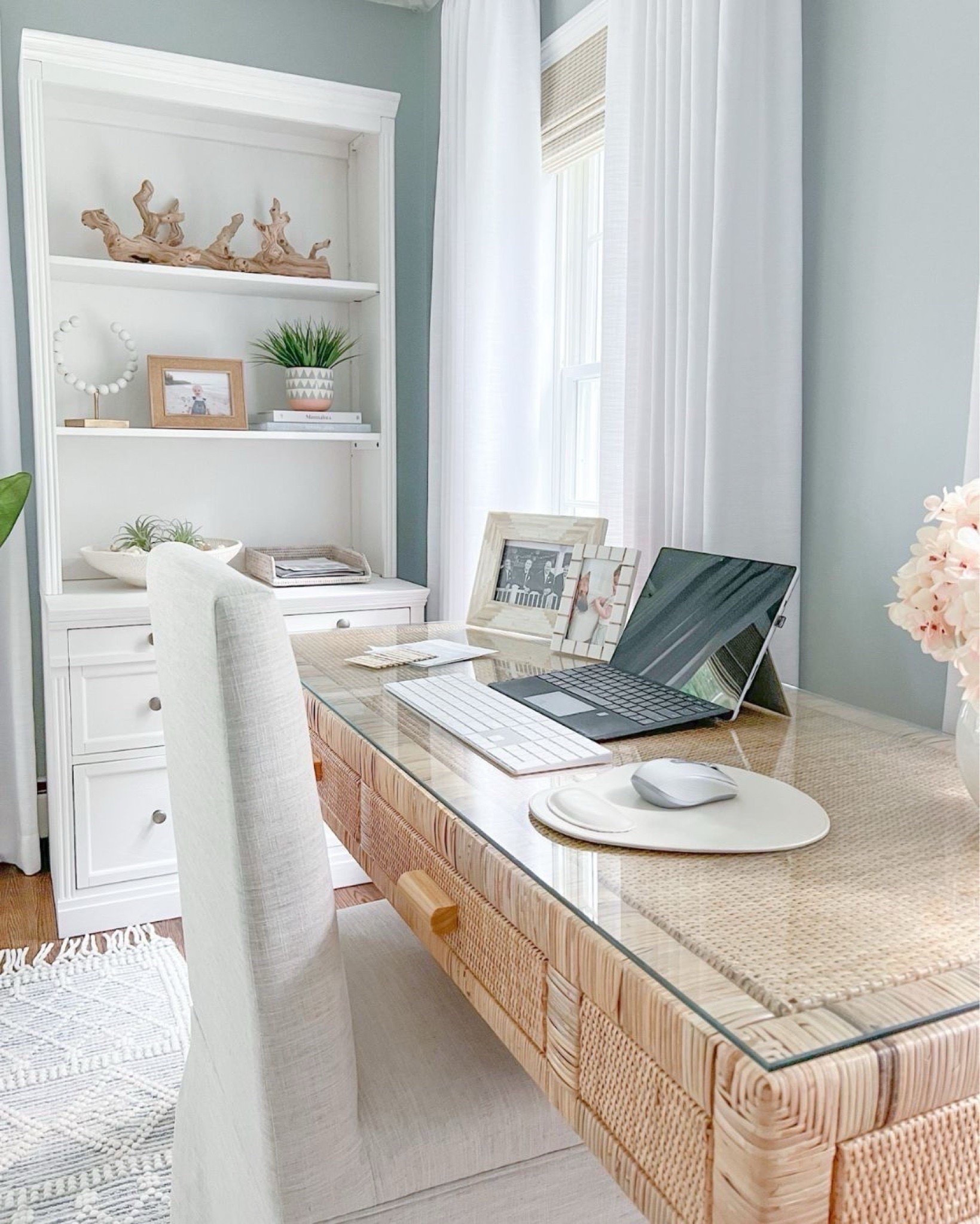 Home office views! I love working in here in the mornings when the sun is streaming through the windows. Desk no longer available but linking a very similar one from Amazon!
-
Home office, office furniture, office rug, coastal home decor, neutral home decor, neutral furniture, coastal desk, rattan desk, woven desk, large rug, faux plant, home office desk, natural desk, beach home style, beach style, coastal style, amazon home decor, bookshelf styling ideas, bookshelf decor, white bookcases, white shelves, white file cabinet, white home office furniture, pottery barn shelves, woven shades, woven blinds, window treatments, driftwood branch, coastal coffee table books, amazon coffee table books, decorative objects, shelf accessories, planters, decorative bowls, bowl filler, picture frames, amazon desks, white curtains, white drapes, amazon curtains, amazon drapes, white vases, amazon vases, office organization, black curtain rod, amazon chandelier, white beaded chandelier, blue & white rugs, coastal rugs, rugs with fringe, textured rugs, 8x10 rugs, 5x8 rugs, 6x9 rugs, desk chairs

#LTKHome