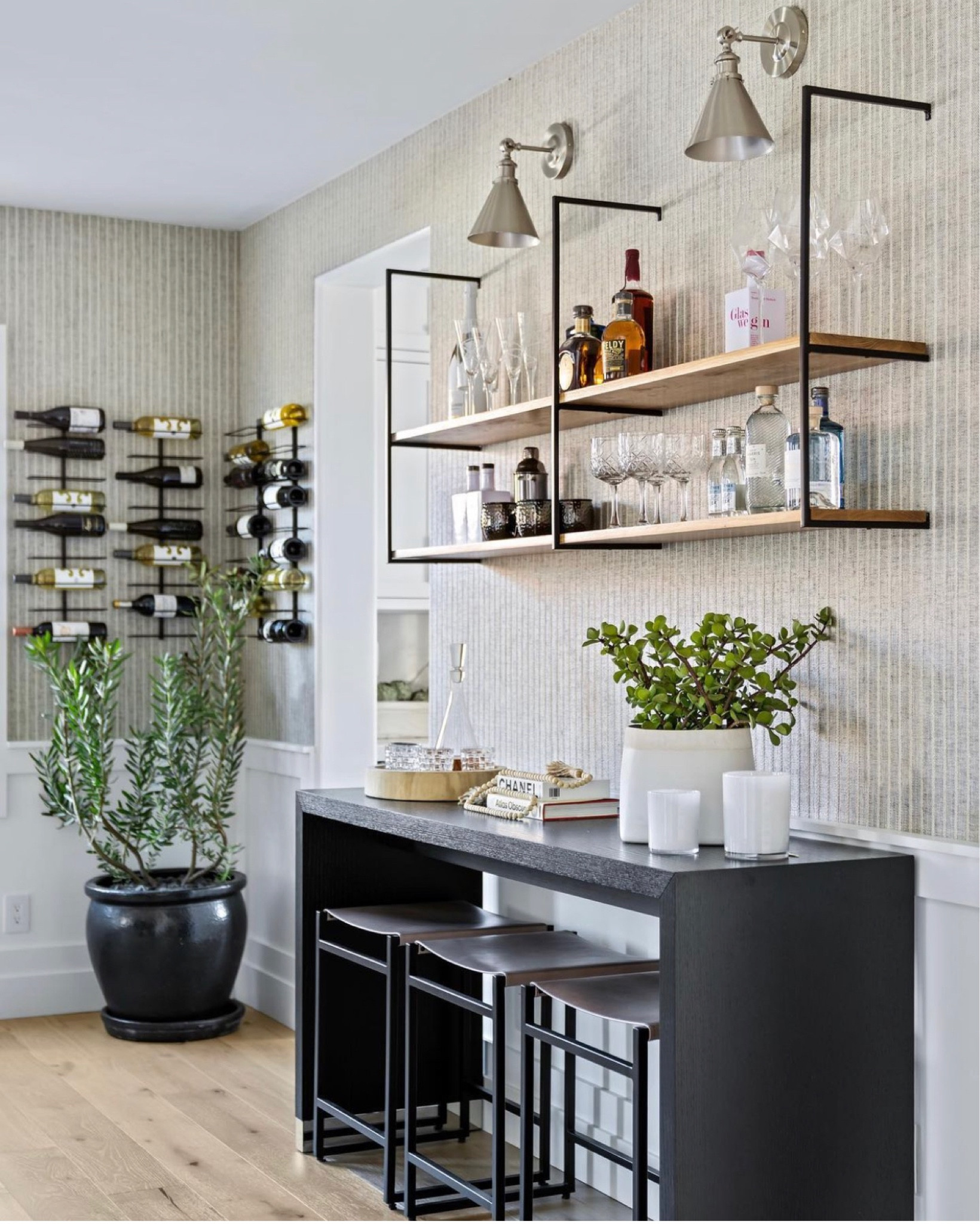 The perfect home bar set up!
With open shelving and wall mounted wine racks. Floating shelves and sconce lighting over a counter height bar table with counter stools for extra seating making a super social space!

#LTKhome