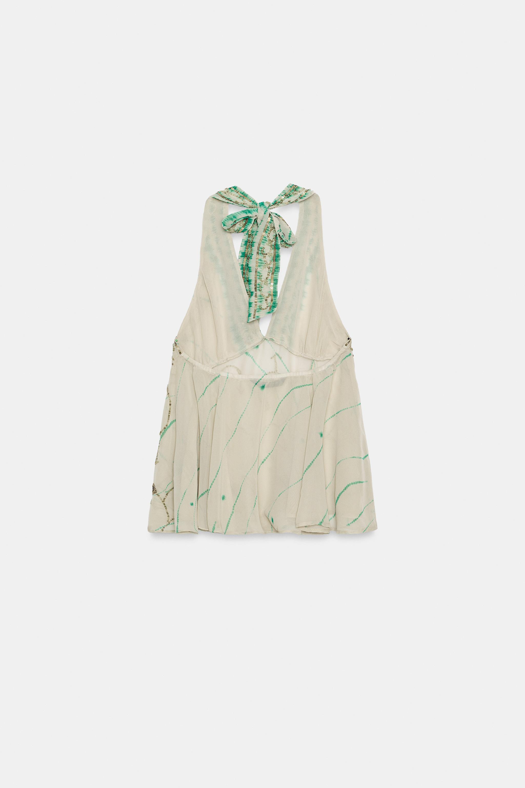 Model height: 181 cmTop crafted in semi-sheer fabric. Featuring a halter neck, V-neck, bead appli... | Zara UK