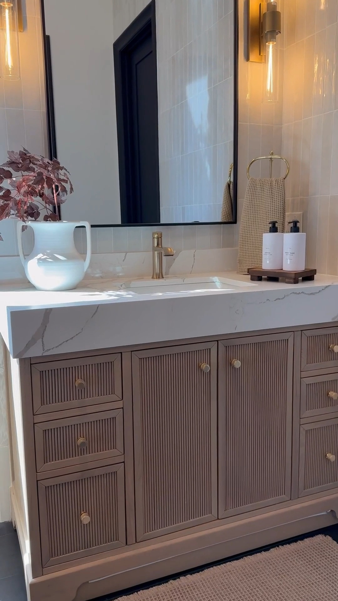 My bathroom vanity feels so warm and inviting with a few seasonal accents like these cimicifuga stems 🌿 The brown accent chair adds the perfect cozy tone 🪑 and I love how the backsplash and vanity combo keep everything neutral while still adding warmth 🤍

My artwork has been such a favorite 🎨 available in so many sizes and styles, it’s perfect 🤩 I’m also obsessed with my white oak console and dining tables that carry that same warmth throughout my home. And this vintage-inspired vase is so versatile, it works beautifully as a planter and adds that timeless look.🏺✨

#LTKHome #LTKSaleAlert
