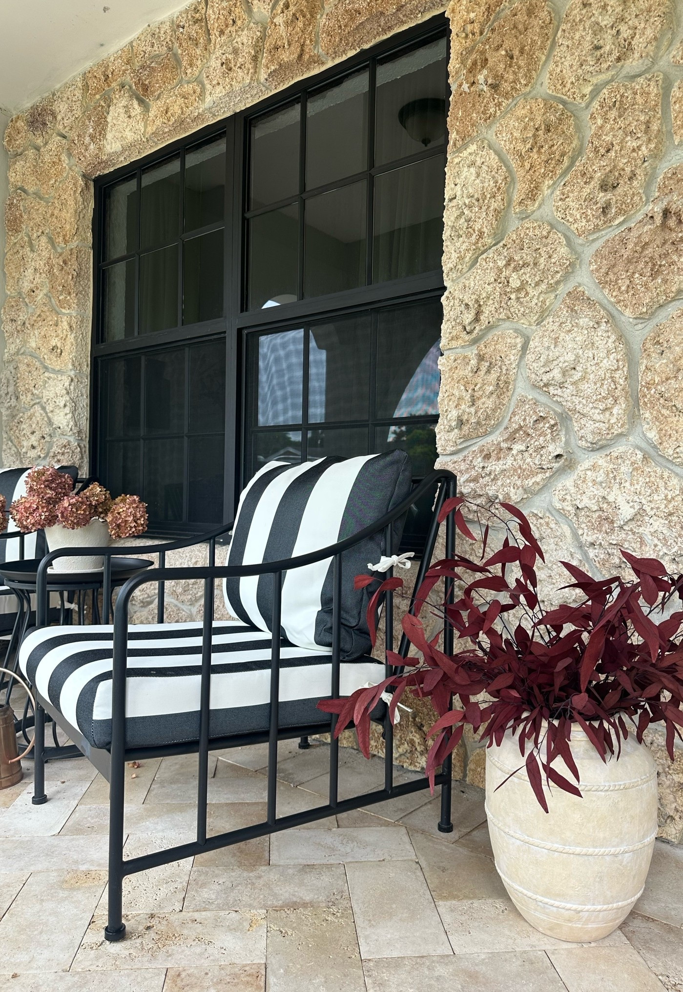 Fall porch decor. Switched out our cushions for striped. Added Fall dried florals. Deep burgundy in this beautiful terracotta pot and dried hydrangeas for the side table. 

Fall porch 
Porch decor
Front Porch 
Cozy 
Fall patio 
Moody 
Stone wall 
Mediterranean 
Aubrey patio set
Walmart home
Amazon 
Cottage 
Pottery barn 
Magnolia 
McGee 
Autumn 
Patio set
Bistro set 
Black iron 
Black and white stripes 
Halloween 
Moody
Small porch

#LTKSeasonal #LTKHome #LTKSaleAlert