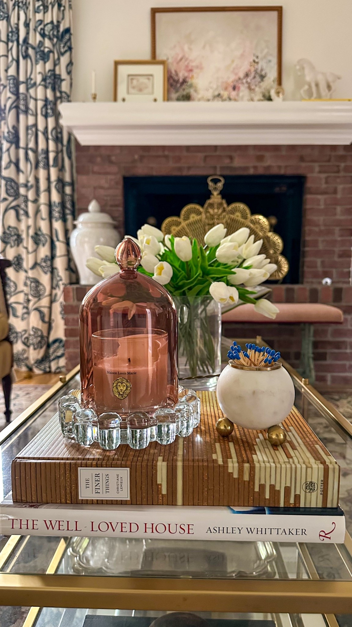 A fresh and simple way to style your coffee table—white tulips, layered books, and warm accents for an elevated everyday look. I’ve linked the candle, vase, tray, and decor pieces to help you recreate this classic and cozy setup at home #coffeetableideas #homedecor #interiordesign

#LTKHome
