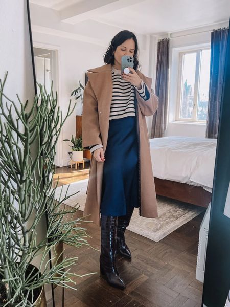 Midi slip skirt with knee high boots and a camel coat. Winter outfitters 

#LTKworkwear #LTKSeasonal #LTKfindsunder100