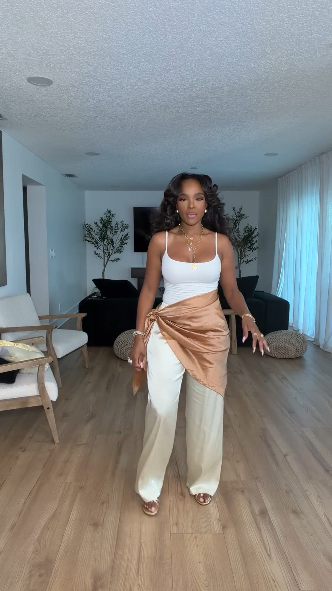 Hi Babes!

This look feels like a luxury vacation outfit without the luxury price tag. The silky champagne pants paired with the white tank create the prettiest neutral palette, while the satin wrap detail instantly makes the entire outfit feel elevated and unique.

I love pieces like this because they look expensive, photograph beautifully, and can easily be styled multiple ways. The soft gold and cream tones are timeless and give that effortless resort-wear vibe that's always in style.

Where to wear this:
• Beachside dinner
• Vacation nights
• Resort getaway
• Rooftop cocktails
• Summer date night
• Cruise dinners

Everything is linked below.

Comment SHOP below to receive a DM with the link to this post on my LTK ⬇

xx Kira | IG: KirasFashionFinds

34D - 27 - 40 • Size Small or 4

#LTKgrwm #LTKootd #LTKPetite