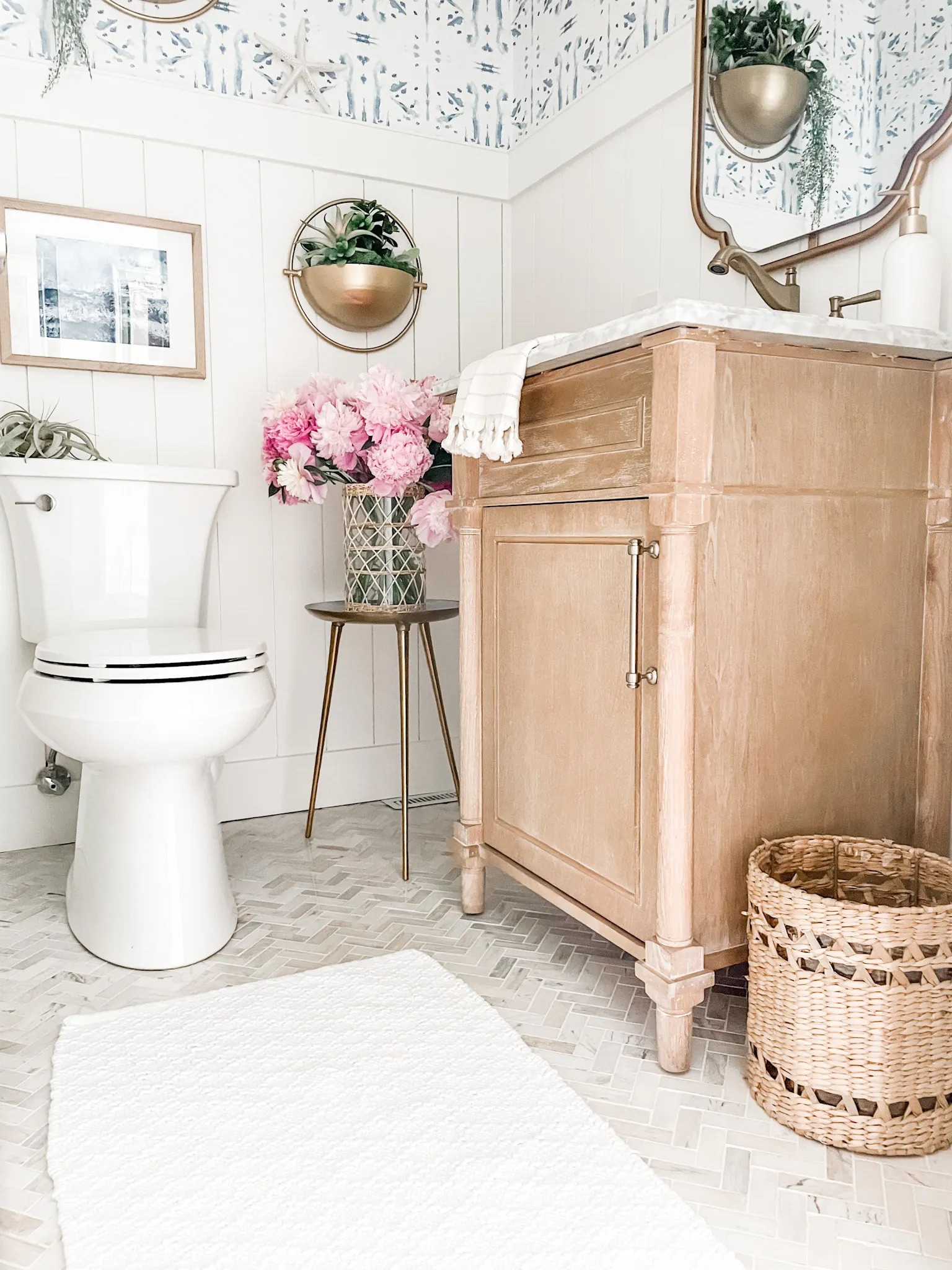 Coastal power room decor.

Gold vanity mirror, warm gold mirror, brass wall mirror, Turkish hand towel, wall decor, hanging wall planter, bathroom soap dispenser, rattan glass vase, three legged table, warm gold faucet, bathroom faucet, bathroom vanity, powder room vanity, natural colored vanity, wicker waste basket, powder room trash can. 
Bathroom decor, powder room rug, Kohler toilet, coastal art, wall art, wall frame, abstract art.
#bathroom #powderroom #wallmirror

#LTKFind #LTKstyletip #LTKhome