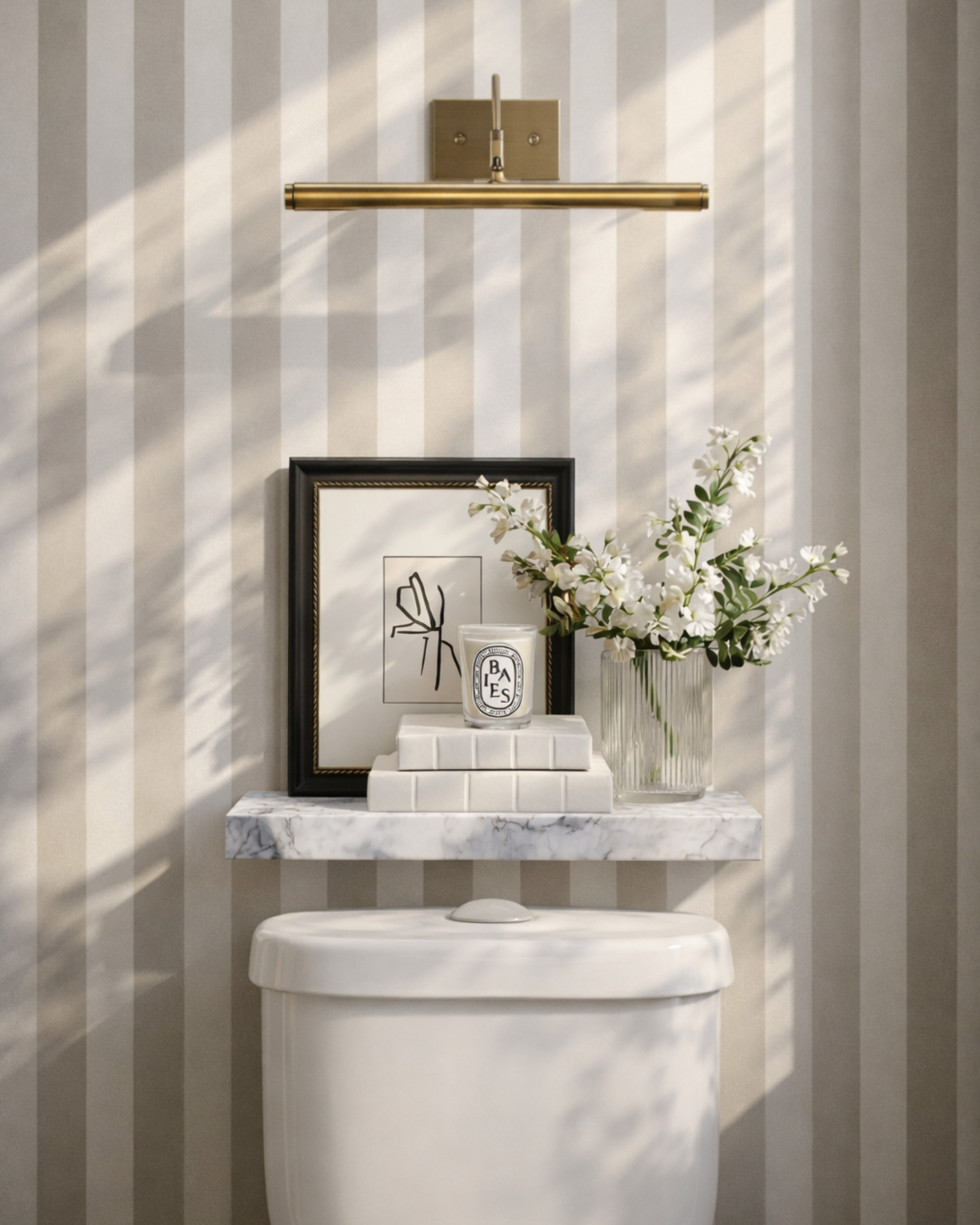 If your powder room feels like an afterthought… this is how you fix it 👇

Small space, but every detail is working harder:
• Vertical stripe wallpaper = instant height + polish
• A picture light turns anything into a focal moment (even a simple print)
• Marble shelf keeps it elevated but minimal—no clutter, just intention
• Layering (frame + books + candle + florals) creates that styled-but-effortless look
• Warm brass against soft neutrals = quiet luxury without trying too hard

This is the difference between a basic bathroom and one that feels designed.

Everything is linked to recreate this exact look—save this for your next refresh 🤍

This post contains affiliate links, which means I may earn a small commission if you shop through them at no extra cost to you. 

 #LTKHome