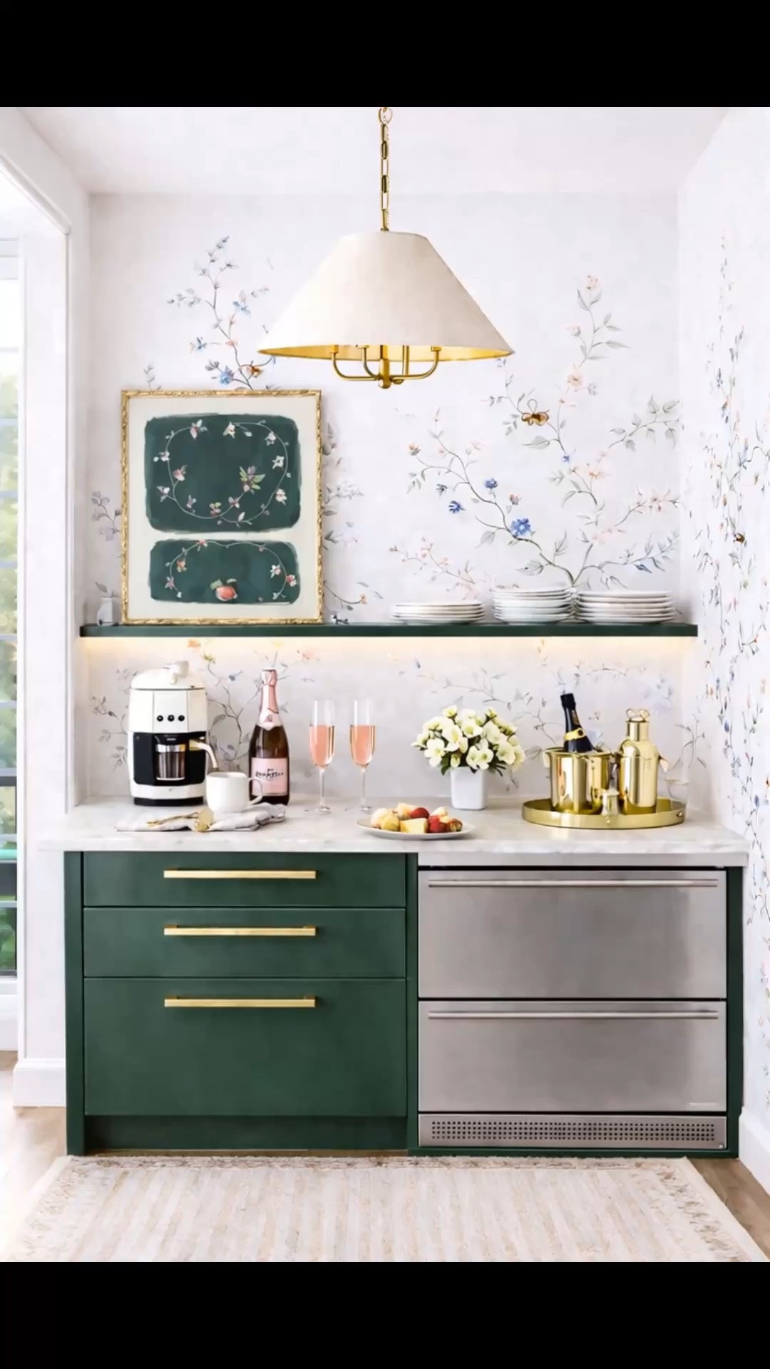 From morning coffee to evening cocktails—this beautifully designed corner transitions effortlessly throughout the day. ✨

In the morning, it’s an inviting coffee station. As the sun begins to set, chilled rosé, elegant glassware, and a brass tray transform it into the perfect home bar—because any evening can be cocktail night.

The delicate chinoiserie wallpaper creates a timeless, collected feeling, while the deep green cabinetry and warm brass accents bring richness and sophistication. I love how the modern pendant, framed artwork, soft pink glassware, and under-counter drawer refrigerator make this corner feel equally beautiful and practical.

A lovely reminder that even a compact corner can become one of the most memorable moments in a home.

#CoffeeStation #HomeBar #CocktailHour #Chinoiserie #ChinoiserieWallpaper #KitchenDesign #GreenCabinets #BrassLighting #BrassDecor #Barware #WineGlasses #InteriorStyling #ModernClassic #CollectedHome #LTKHome #LTKdayinmylife

#LTKdayinmylife #LTKHome