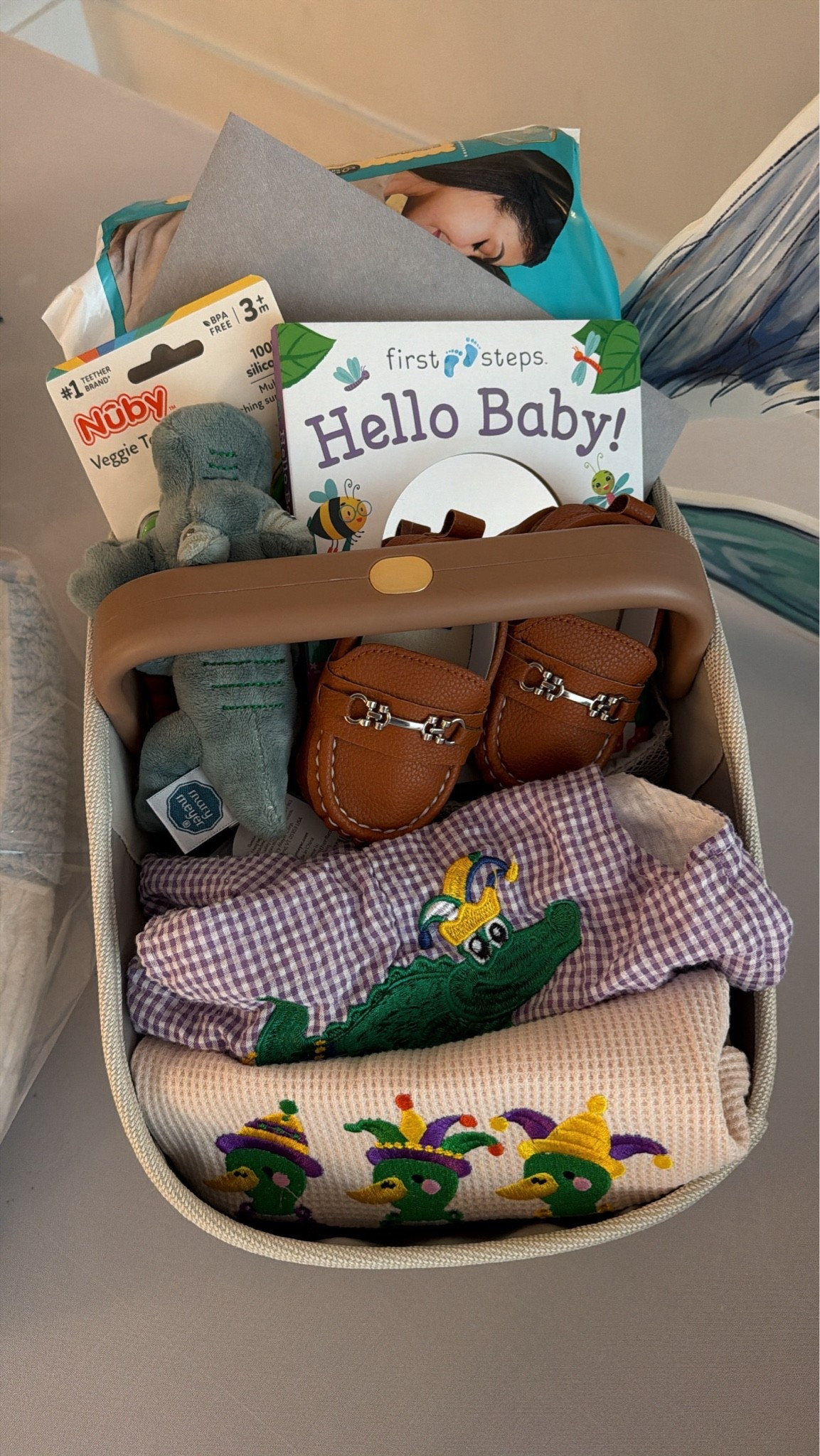 Louisiana baby shower gift idea! Diaper caddy, pampers baby wipes + diapers, baby loafers, mardi gras onesies, alligator rattle and corn nubby teether, baby mirror book

#LTKBaby #LTKKids #LTKBump