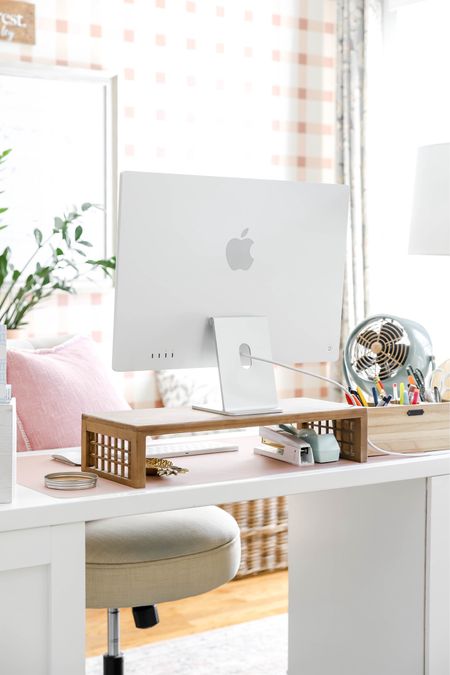 My home office features a white desk with swivel chair, an Apple desktop on a raised stand, and other organizational items.

#LTKHome