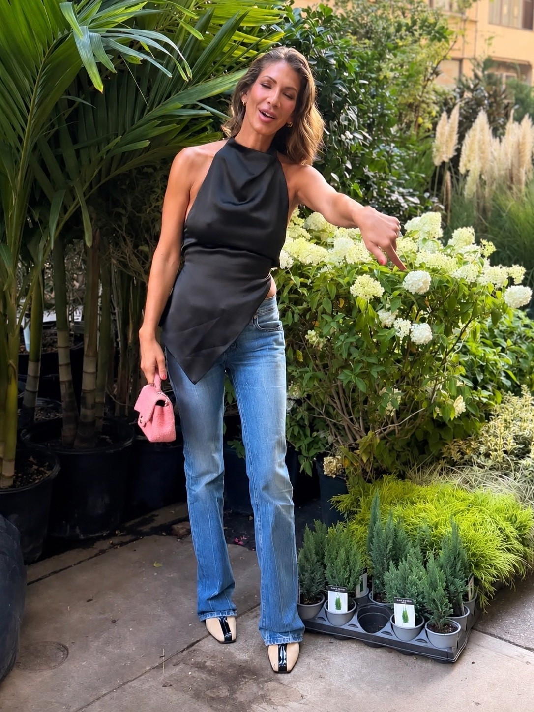 Erin Lichy just found the perfect formula for girls’ night style. A black asymmetric draped halter top paired with low rise bootcut jeans gives that effortless dressed up denim look I love. The color block slingback square toe pumps add a polished, fashion forward finish without trying too hard. This is such a chic date night, dinner or girls’ night outfit to recreate for fall. Save this one for your next night out.

#ErinLeci #CelebrityStyle #CelebrityFashion #GirlsNightOutfit #