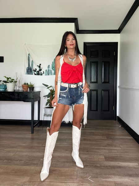 Red bow tank paired with white boots, belt, and crochet vest! Shorts are super stretchy with rhinestone fringe detail! LORI20 to save! 
Added similar vests bc this one is no longer available!

#LTKFestival #LTKStyleTip #LTKSeasonal