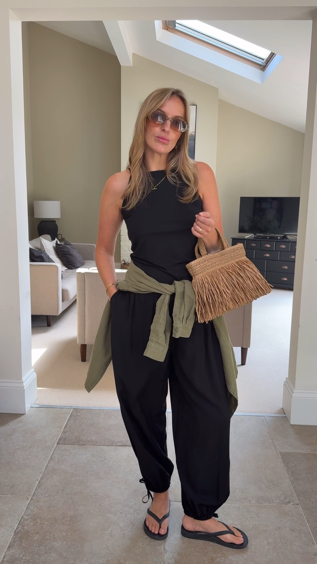 Black balloon trouser styling 
A great comfortable trouser option
Lightweight fabric , loose silhouette with adjustable tie detail at hem . 
Sizing 
Trousers U.K. 14 , roomy
Vest - U.K. 14 
Linen shirt U.K. 14

#LTKsummer #LTKtravel