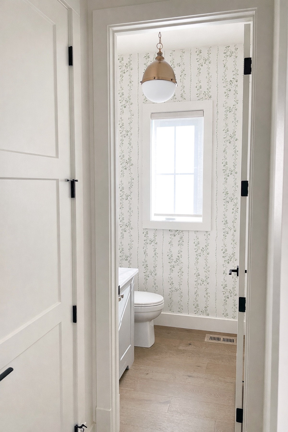 Do you love a little design touch in the powder room too? This subtle floral striped wallpaper adds texture and charm while making the brass light fixture really pop. I’ve linked a few of my favourite wallpapers in this style if you want to try something similar!

#LTKSaleAlert #LTKHome