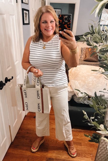 Relaxed, neutral summer outfit.
This striped tank top and linen pants make such a polished, timeless look.
This outfit is as comfortable as wearing leggings and a t-shirt, but looks so much more put together. 
This is a great outfit for work or casual day out.
Spring outfits, summer outfits, work outfits, Chloe, Woody tote, wedge sandals, affordable outfits 

#LTKSeasonal #LTKfindsunder50 #LTKworkwear