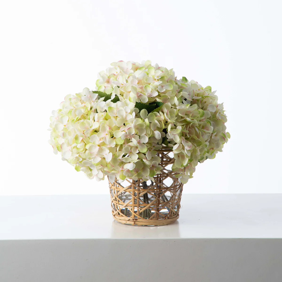 Cream & Green Hydrangea Blooms in Rattan Wrapped Vase Faux Floral Everyday Spring Water Illusion ... | Darby Creek Trading