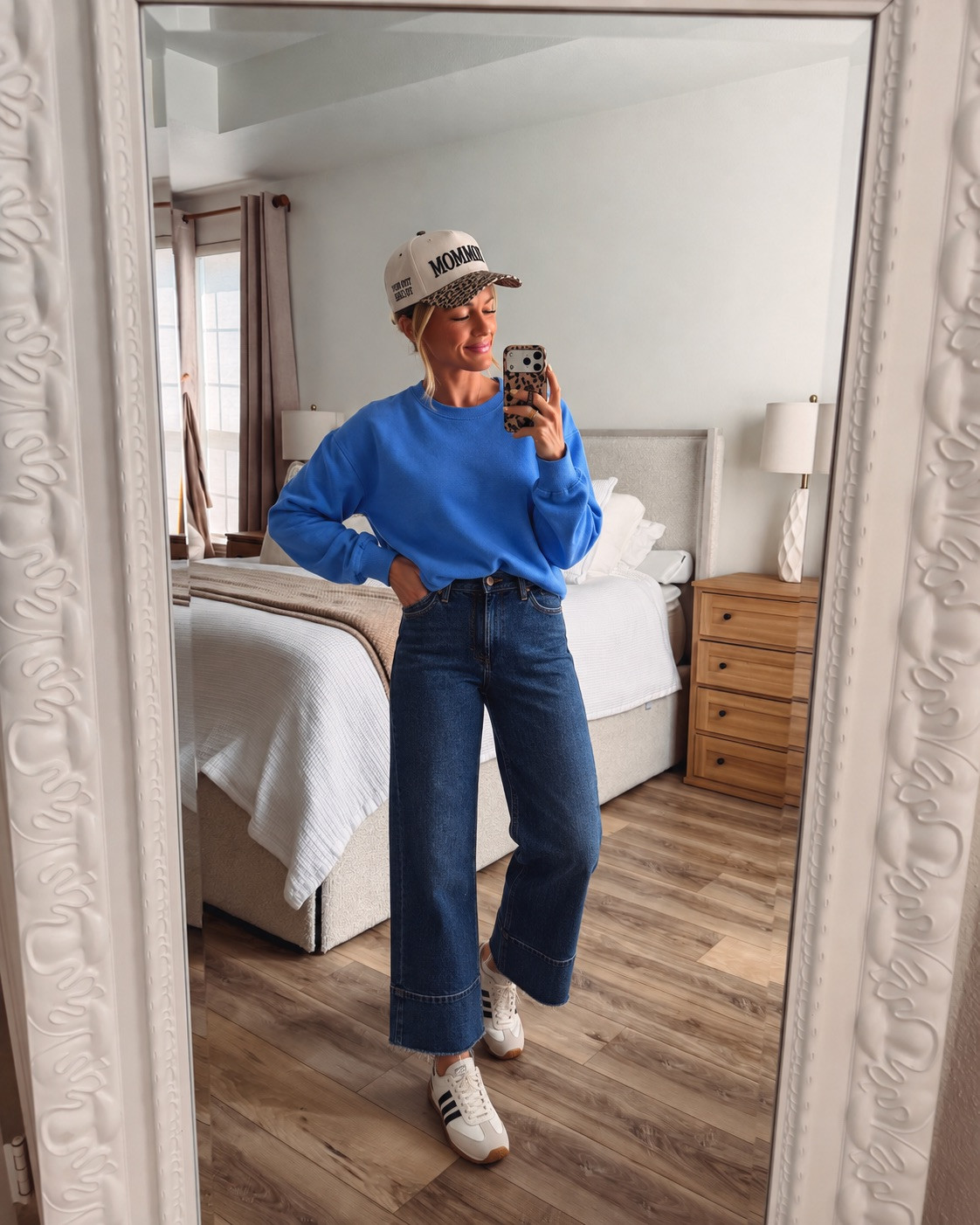 Casual mom-mode perfection! This bright blue crewneck sweatshirt is so comfy paired with dark wash wide leg jeans for that easy everyday look. Add a trendy trucker cap and striped sneakers to keep it fun and sporty. Perfect for school drop-off, coffee runs, or busy days out and about! 

 #LTKootd #LTKmomlife #LTKSeasonal