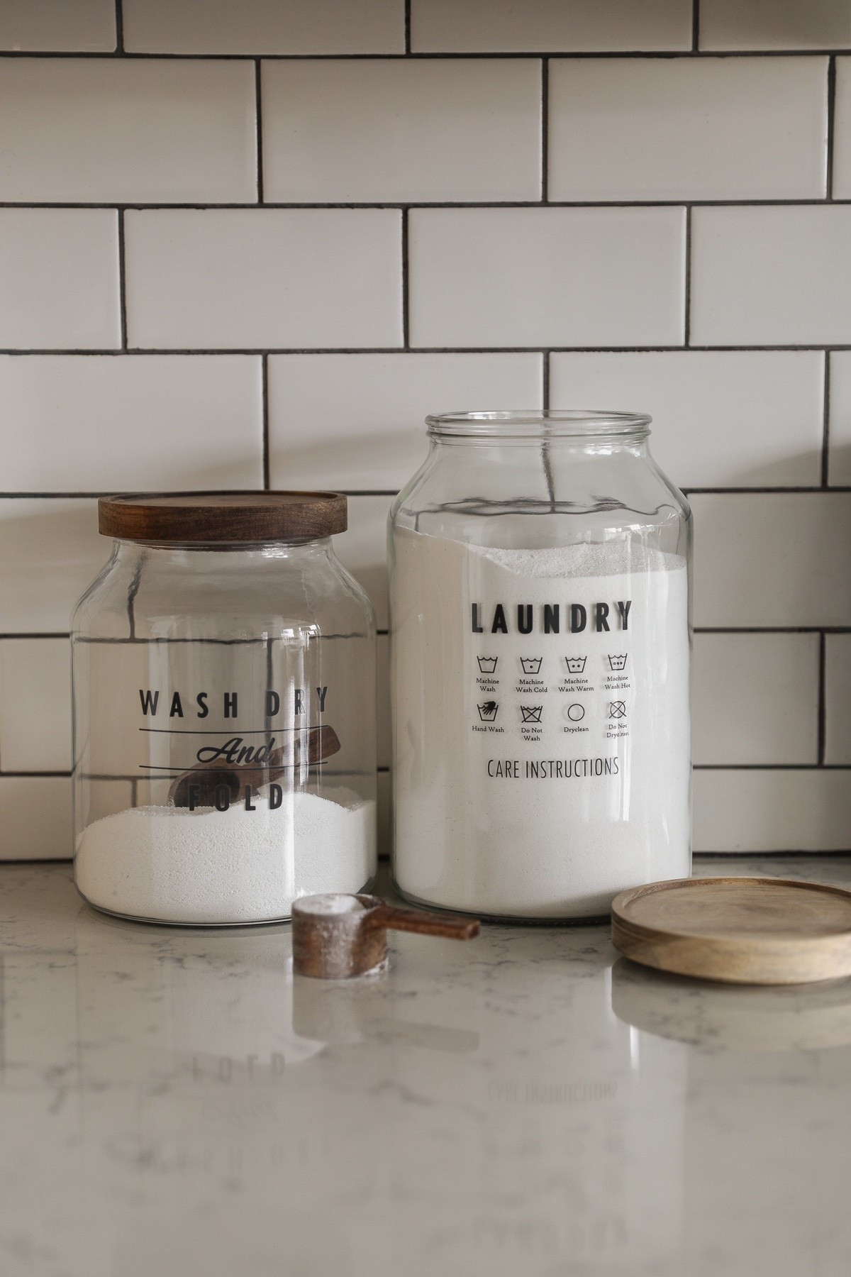 For the last 14 years my laundry has been done in a dark, cobweb-filled little corner of our unfinished basement. I dream of one day having a pretty laundry room filled with sunlight and tons of storage, but until that day comes, I'm going to make tiny upgrades that make this unpleasant chore a little more enjoyable. 

For example: decanting our laundry detergent into simple, stylish glass containers. It takes something that looks messy and chaotic with all the random, colorful packaging and turns it into something that actually feels calm and intentional.

These huge jars were under $12, and they’re perfect for powdered laundry detergent. Such an easy upgrade that instantly makes the space feel more pulled together.

And if you're wondering about what I use to clean our clothes these days… I have a few non-toxic laundry products I’ve been loving lately.

#LTKdayinmylife #LTKHome