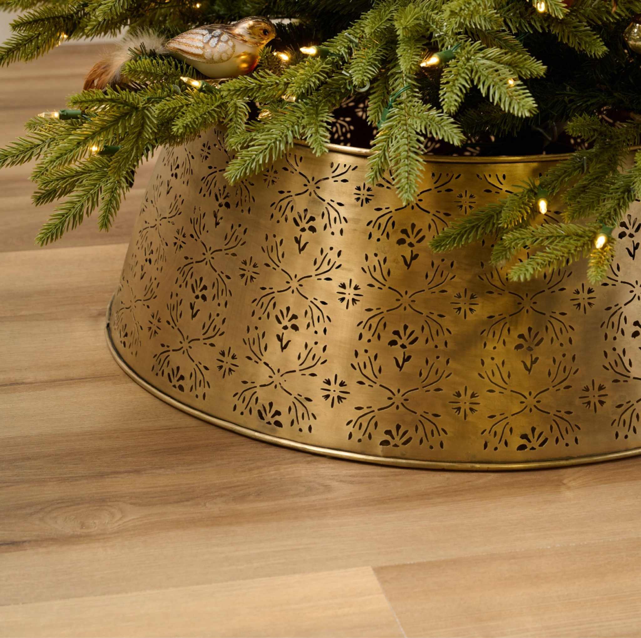 Christmas 🎄 Antique Brass Tree Skirt from Magnolia ♥️ Made from iron with an antique brass finish, this tree collar features a hand-drawn design that was perforated into metal as a repeating pattern. With a tall, wide silhouette, this tree collar is substantial enough to elegantly wrap around any festive fir while concealing tree stands. 

#LTKHome #LTKSeasonal #LTKHoliday