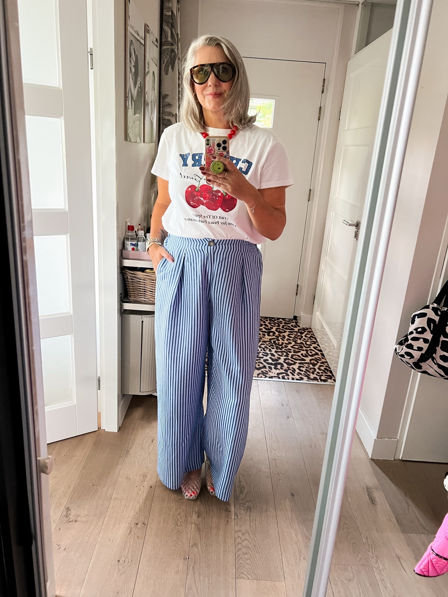 OOTD - Zondag. Cherry 🍒 print t-shirt (40/42) op een blauw gestreepte zomerbroek (42) jelly schoentjes met een glittertje (vallen goed op maat) een rode kralenketting en een hippe zonnebril (wishful thinking)

#LTKnederlands #LTKeurope #LTKsummer
