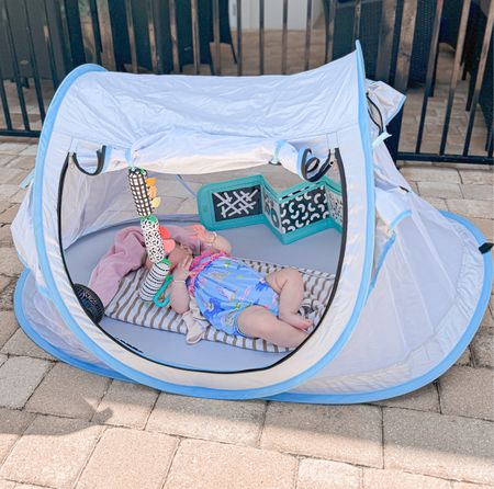 Simple travel baby tent for on the go! I’ve used this same one with AJ you can even lay a baby lounger in it for something a little more cozier, I just had some folded towels for Layla for padding this time & took some toys from home for it plus our stroller fan! 

#LTKbaby #LTKswim #LTKSeasonal