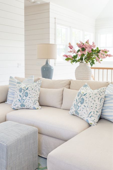 Our loft living room decorated for spring! I used these pink lilac stems, ribbed white vase, colorful oushak rug, linen sectional, light wood console table, blue lamps, striped ottoman cube, brushstroke throw pillow and floral pillow for pops of spring. See our full spring home tour here: https://lifeonvirginiastreet.com/2024-spring-home-tour/
.
#ltkhome #ltksalealert #ltkfindsunder50 #ltkfindsunder100 #ltkstyletip #ltkseasonal spring living room, sectional styling, colorful spring decor

#LTKhome #LTKsalealert #LTKSeasonal