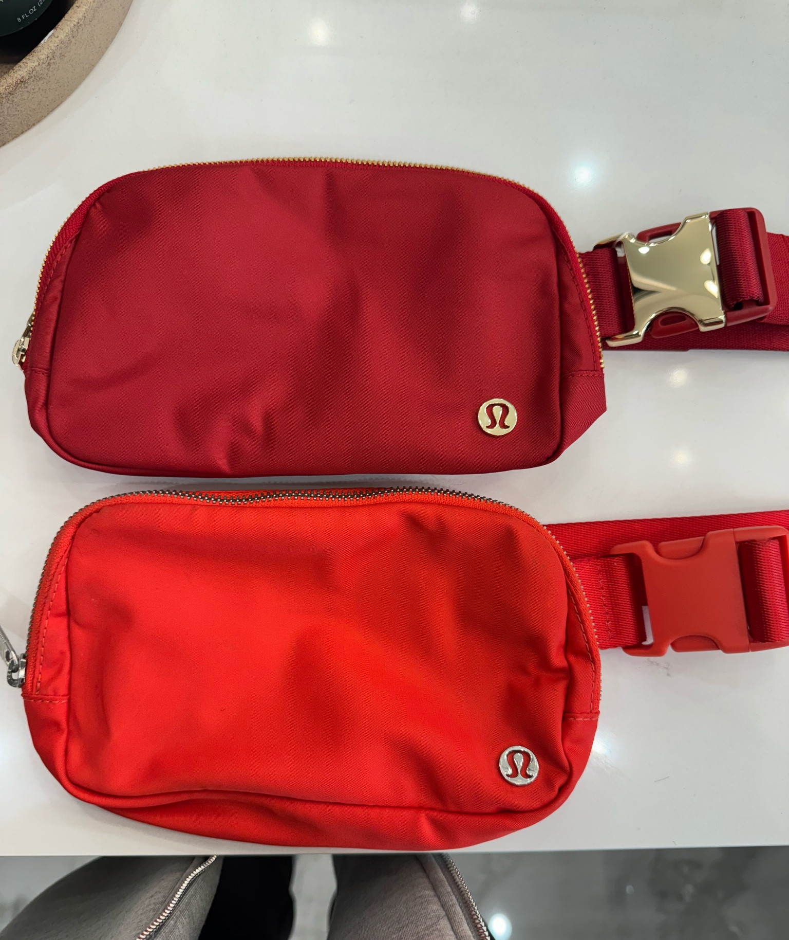 Comparing the new red Lulu belt bag to my old one (new is darker one)