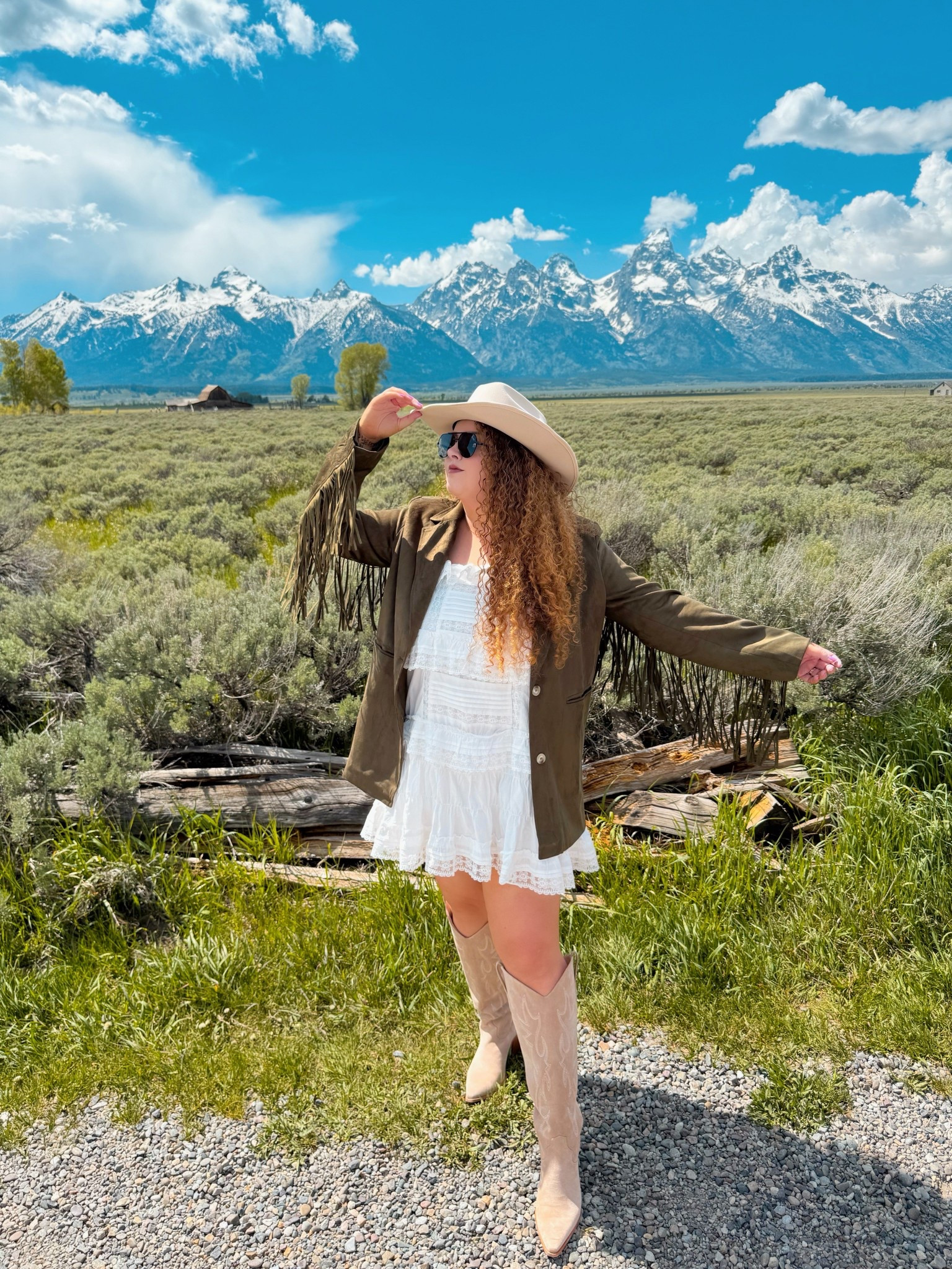 White ruffles, green fringe, and mountain magic 🤍💚 the Grand Tetons behind me, the wild west in my step 🏔️👢 cowgirl hat on, chasing beauty in every direction 🤠✨ concert outfit | concert look | boho cowgirl | Nashville outfit | Nashville bachelorette look | Morgan wallen concert outfit | Taylor swift concert outfit | country concert outfit | western concert outfit | concert season | cowgirl boots | amazon cowgirl boots | beige cowgirl boots | amazon beige cowgirl boots | amazon boots | amazon finds | amazon fashion | amazon outfit | amazon look | amazon concert outfit | amazon concert finds | western concert outfit | western fashion | amazon western fashion | amazon western outfit | dress | amazon dress | amazon white dress | white dress | ruffle dress | white ruffle dress | amazon cowgirl hat | cowgirl hat | amazon neutral cowgirl hat | spring concert | spring concert outfit | spring western outfit | green blazer | amazon green blazer | green fringe blazer | amazon fringe blazer  

#LTKMidsize #LTKSummerEdit #LTKSaleAlert