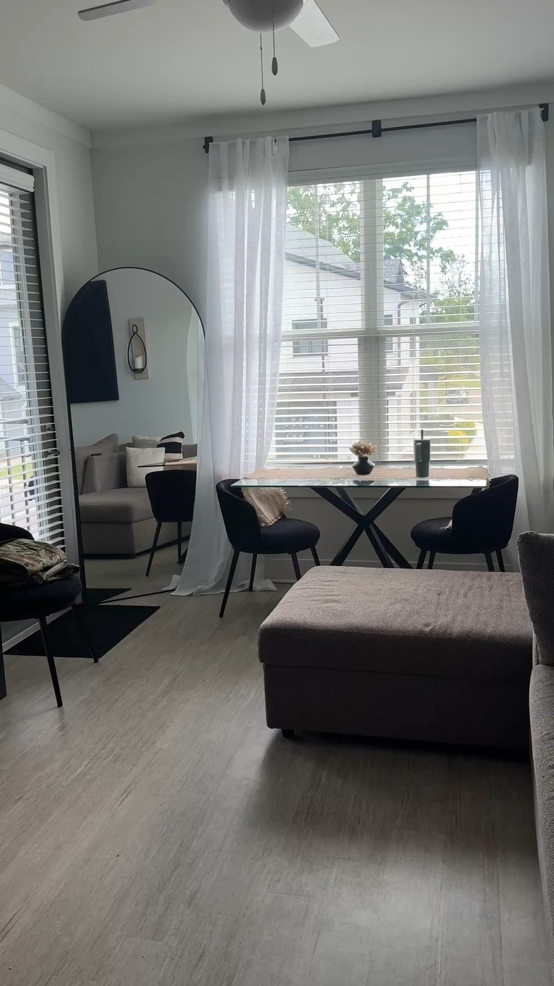 Oversized Arched black mirror, glass dining table, black dining chairs, Fireplace tv stand, neutral dining room, teddy chairs black, bold dining room aesthetic small apartment hacks, black home decor #blackhomedecor #diningrpominspo

#LTKHome