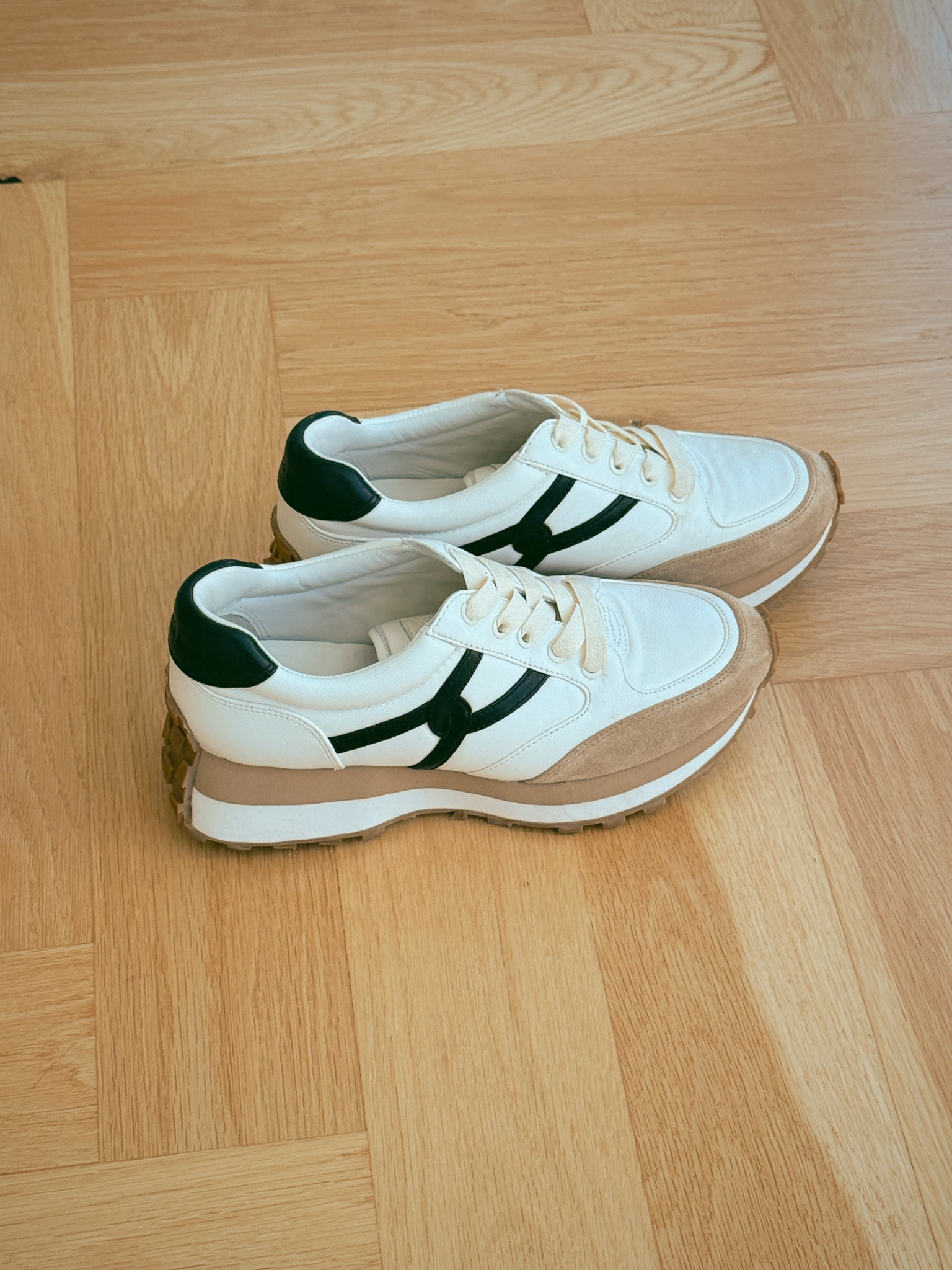 The Veronica Beard Valentina sneakers… slip-on style, no laces to mess with.

The versatile white, tan, and black color combo will go with so much of what’s already in your closet. There’s also a small platform for a little extra height, especially good news if you’re petite like me.

Three years as a Busbee bestseller for a reason!