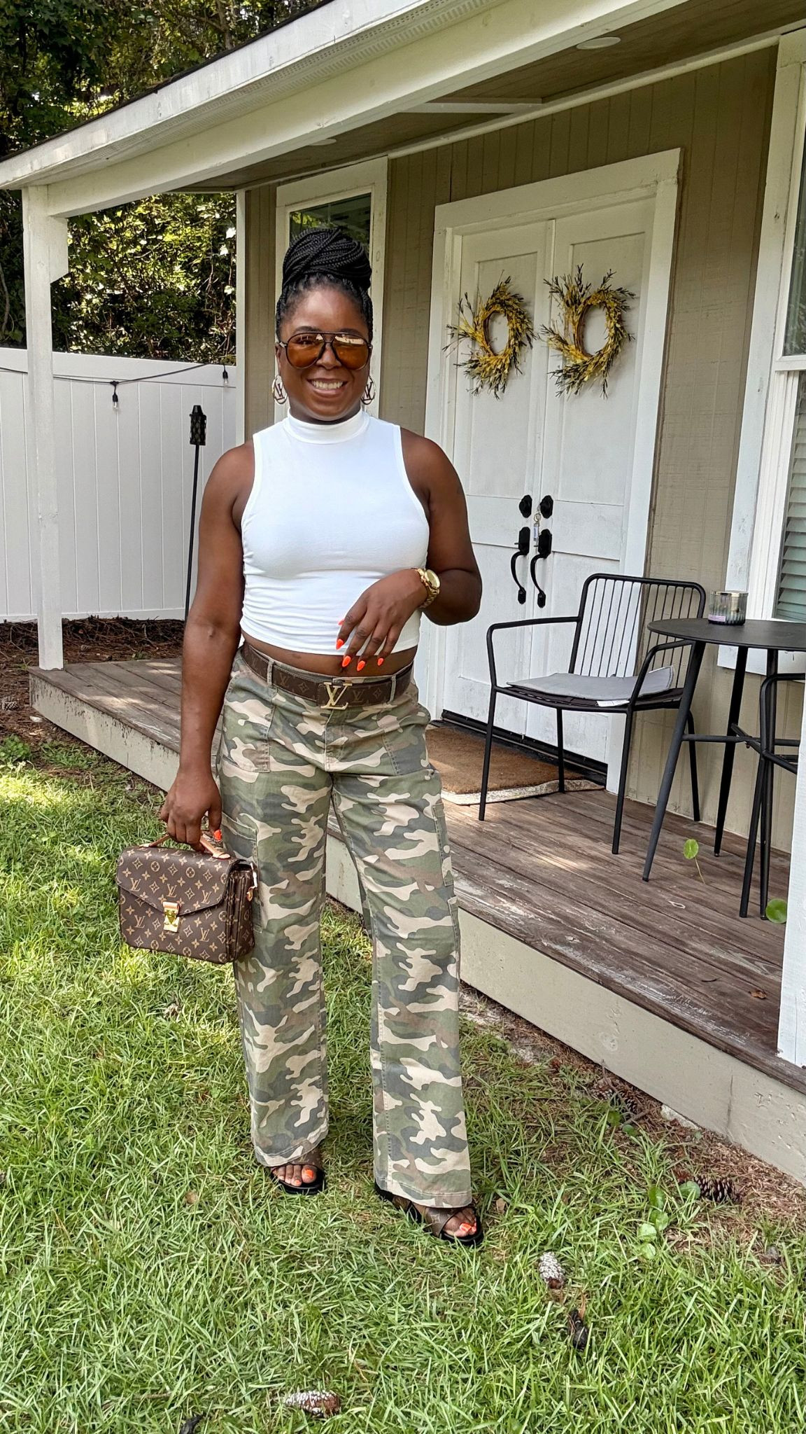 How to style wild camo cargo pants. I styled this elevated casual outfit with a white crop top, LV double buckle slides and LV crossover bag. 

 #LTKOver40 #LTKSaleAlert #LTKBeauty