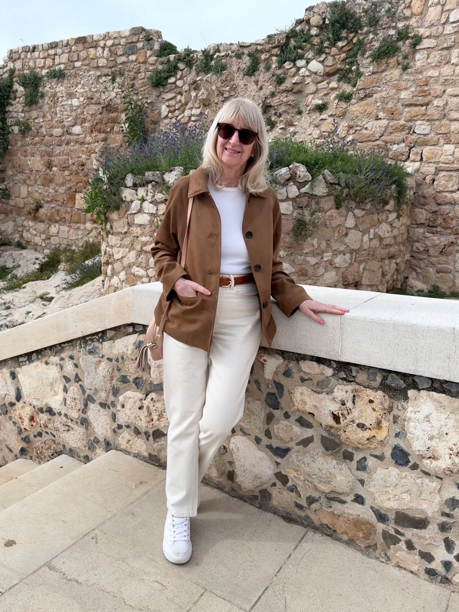 Tan faux suede jacket with ivory cotton rich straight-leg jeans with white t shirt , trainers and tan leather belt for visiting Spain in Spring 

#LTKspring #LTKtravel #LTKeurope